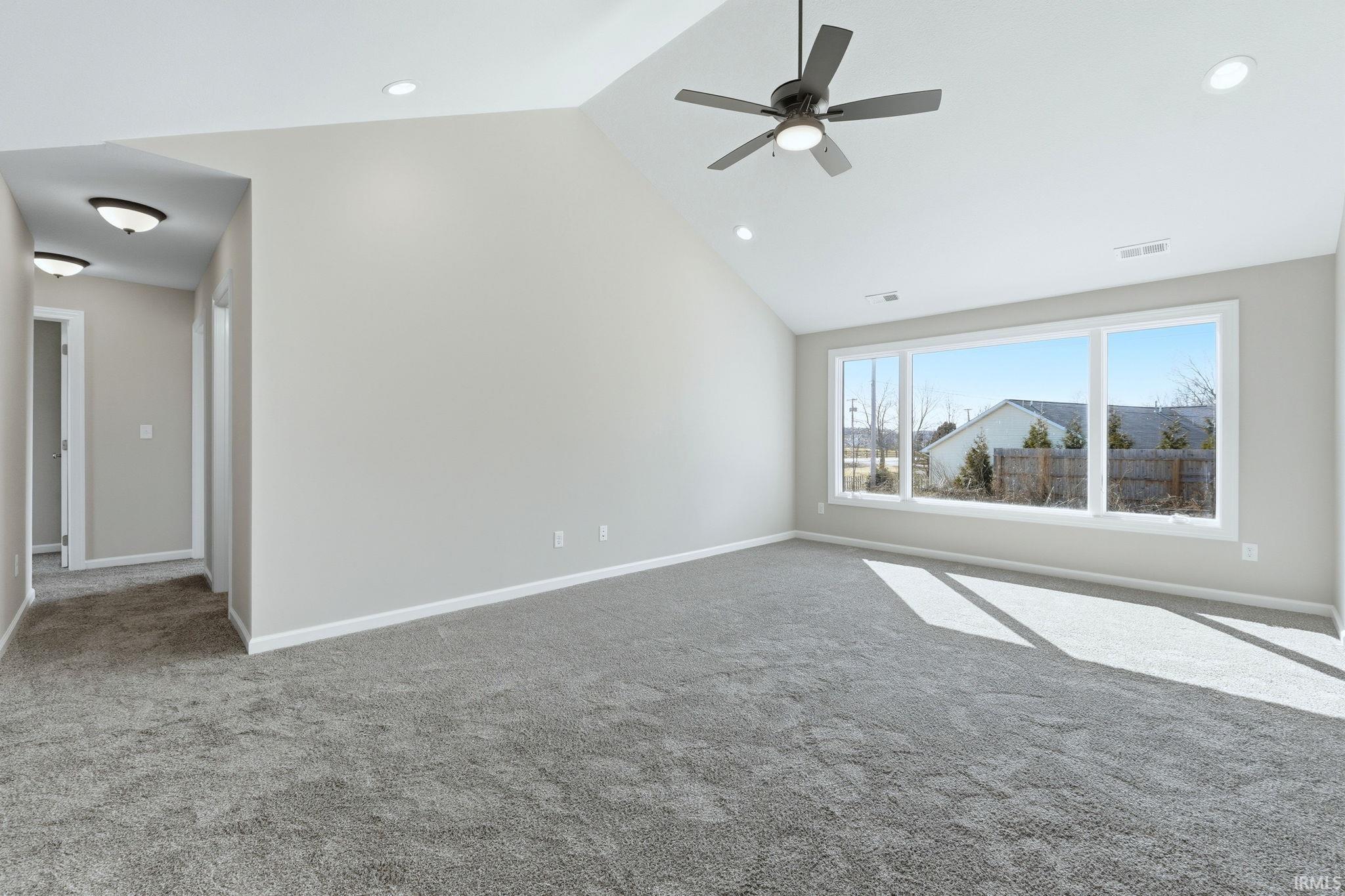 Unfurnished room with a ceiling fan, carpet floors, a high ceiling, and recessed lighting