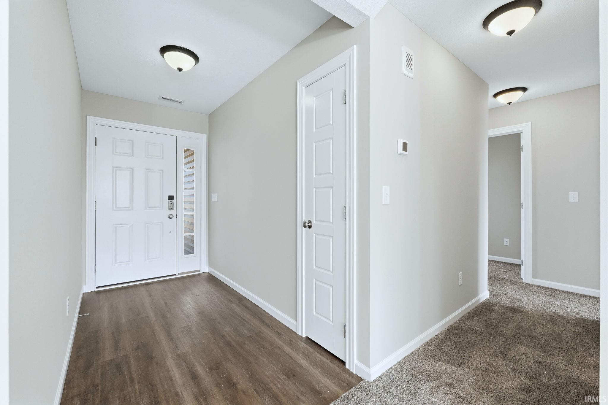 Foyer featuring baseboards and dark wood finished floors