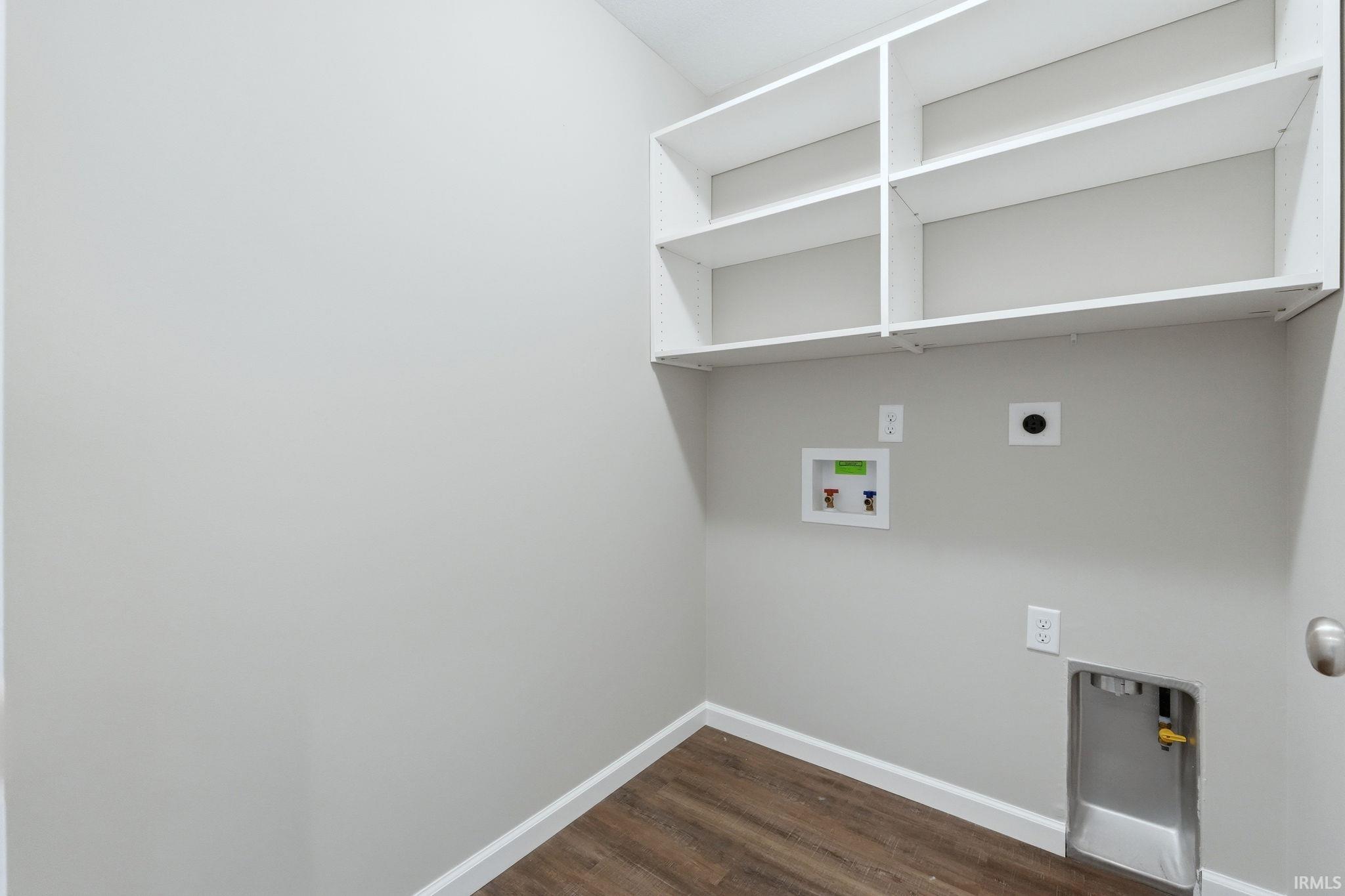 Laundry room with dark wood-style flooring, hookup for a washing machine, and hookup for an electric dryer