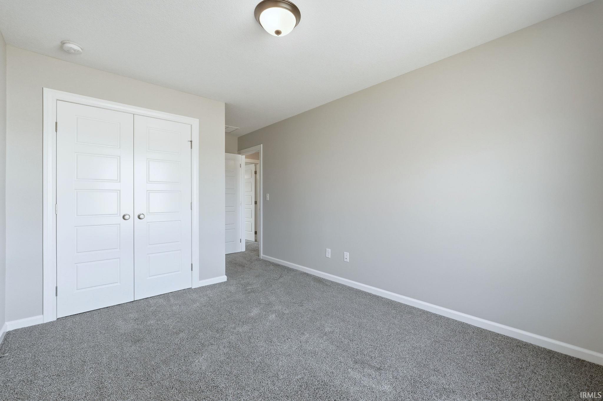 Unfurnished bedroom with carpet floors and a closet