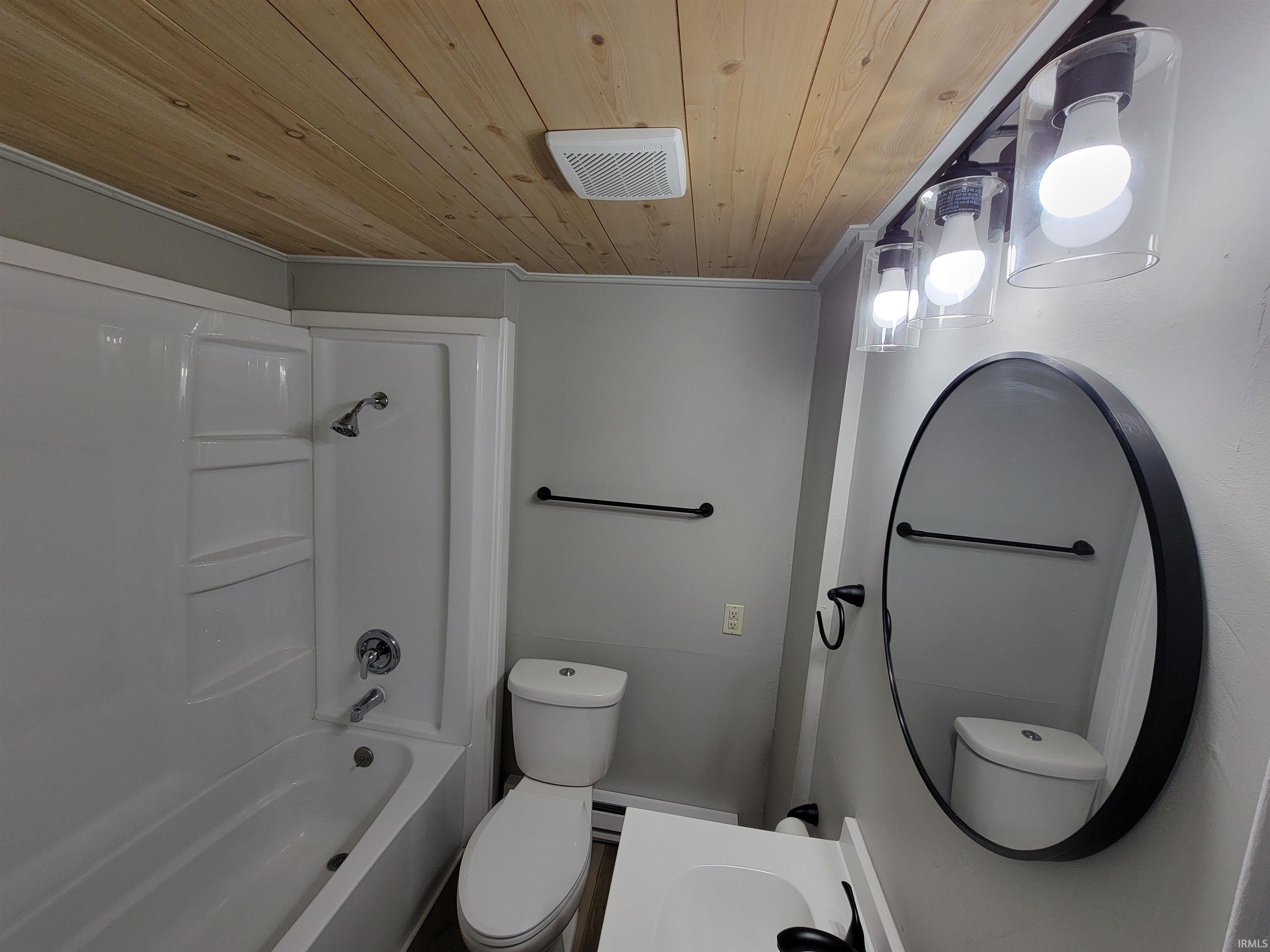Bathroom featuring vanity, wood ceiling, and bathtub / shower combination