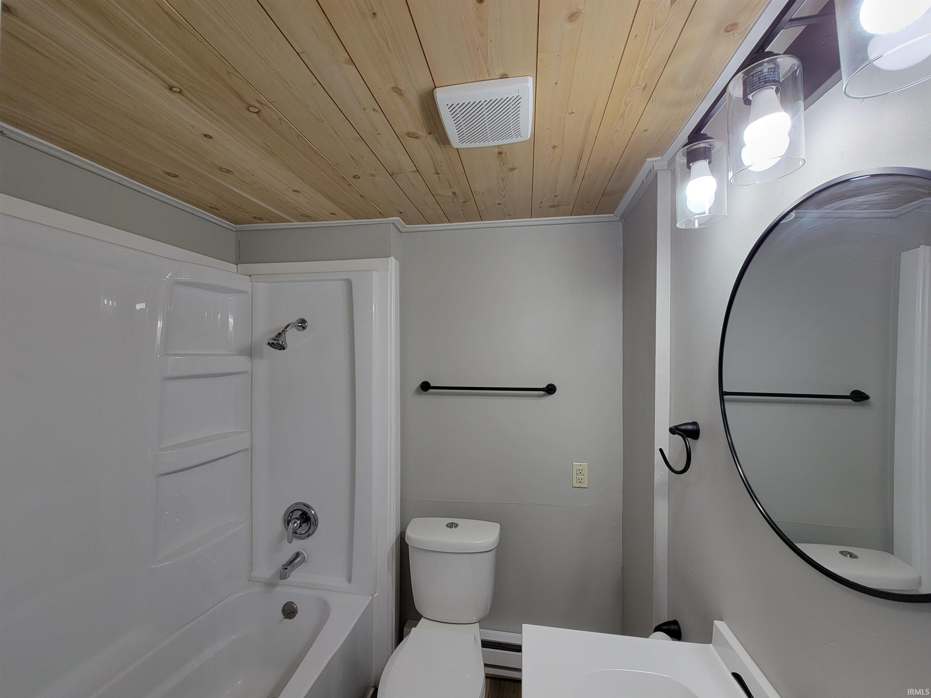 Full bath featuring vanity, wood ceiling, shower / bathtub combination, and a baseboard radiator