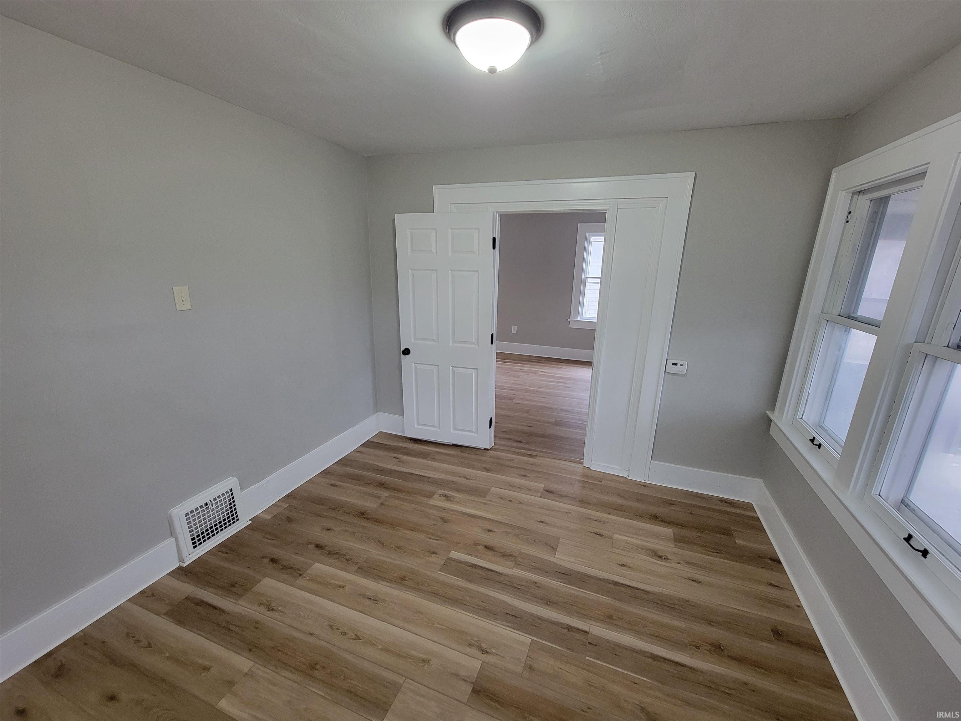 Empty room featuring light wood-style flooring and baseboards