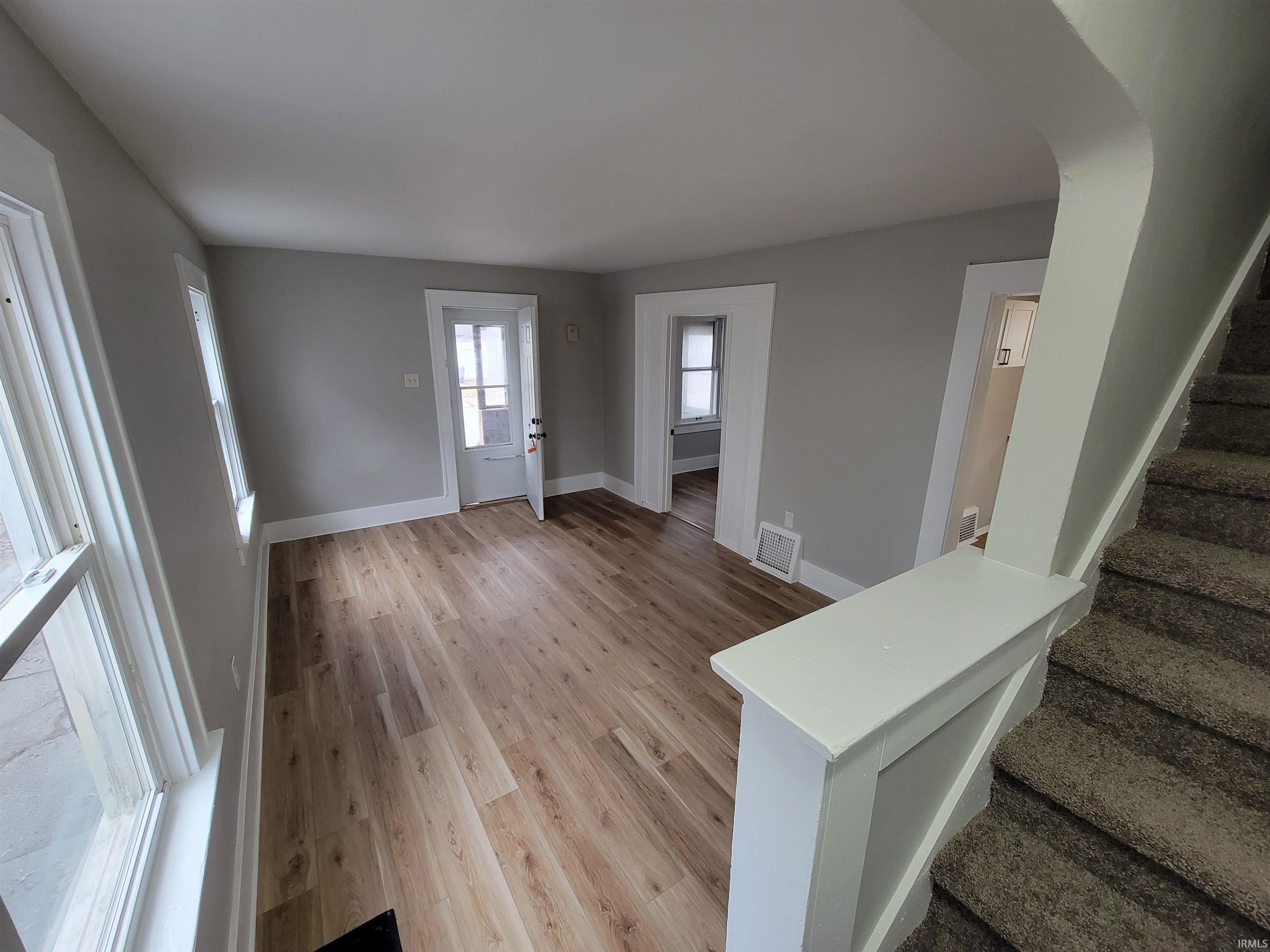 Entrance foyer featuring light wood-type flooring and stairway