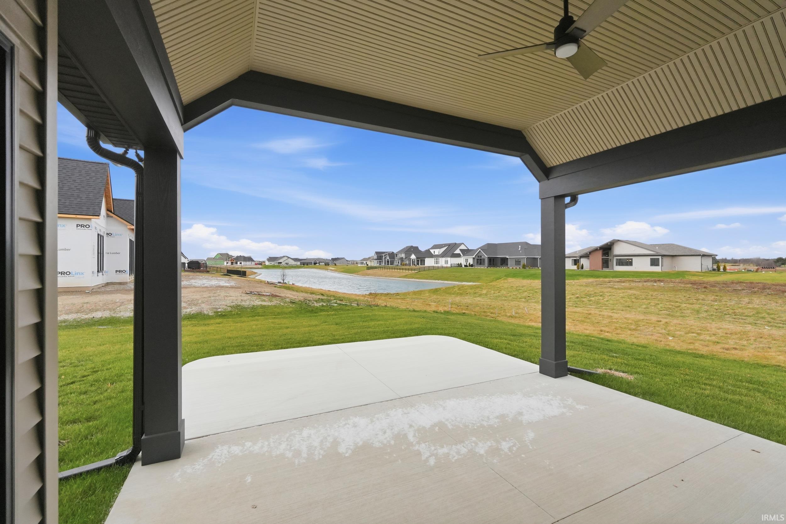 View of patio / terrace featuring a residential view, ceiling fan, and a water view