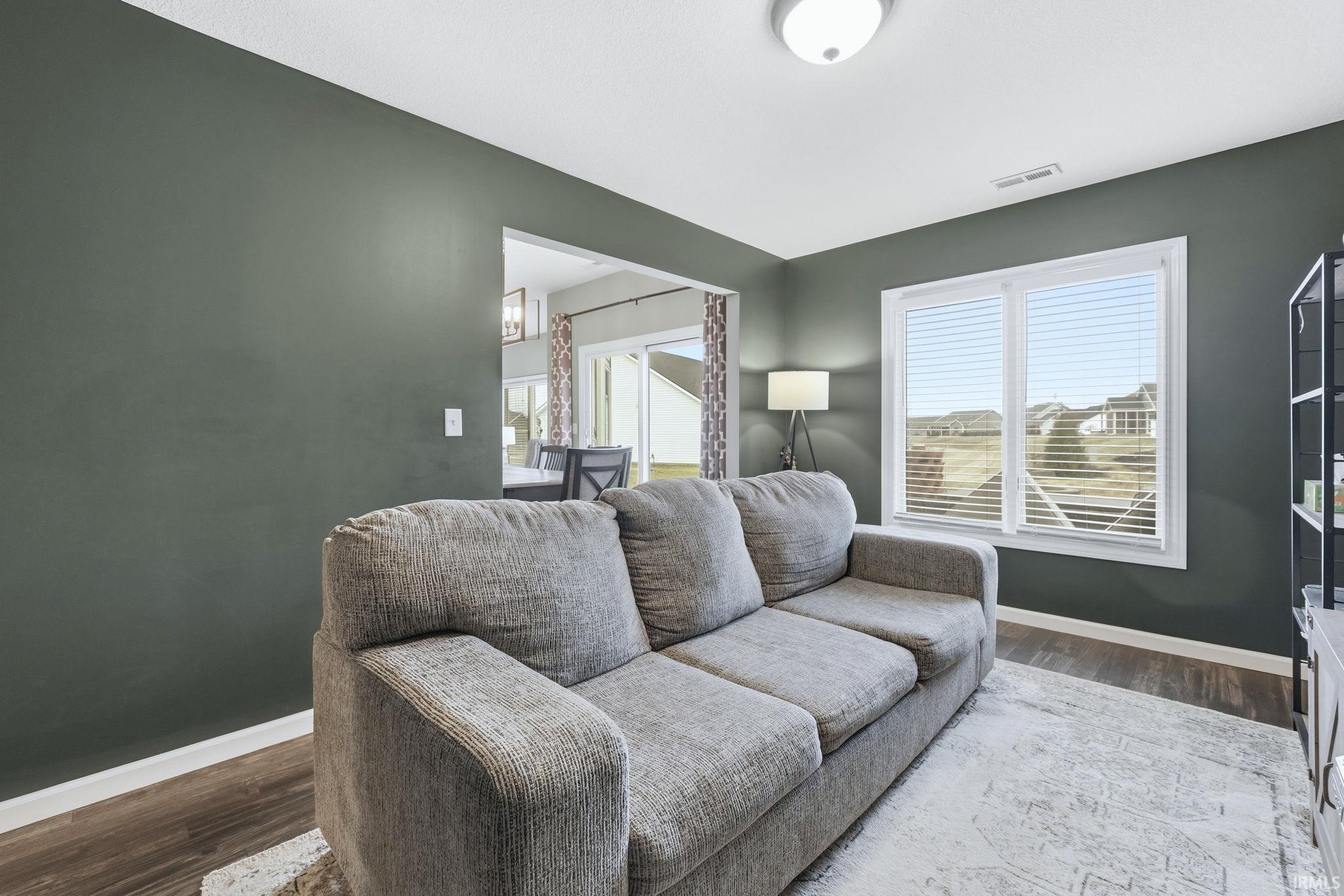 Living area featuring baseboards and wood finished floors