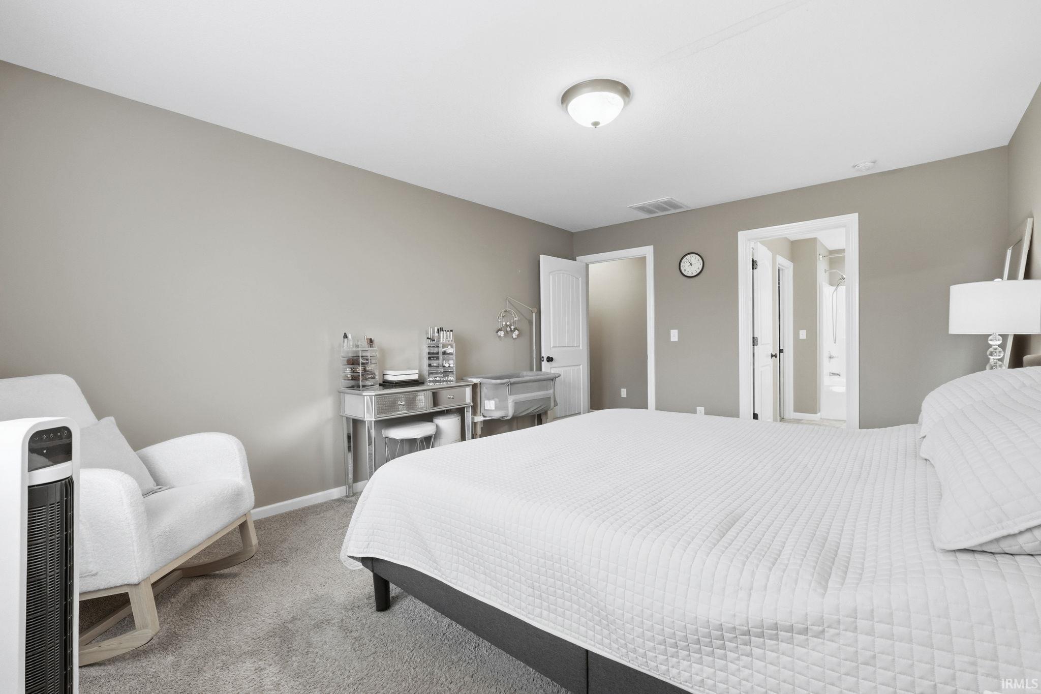 Bedroom with carpet floors and ensuite bath
