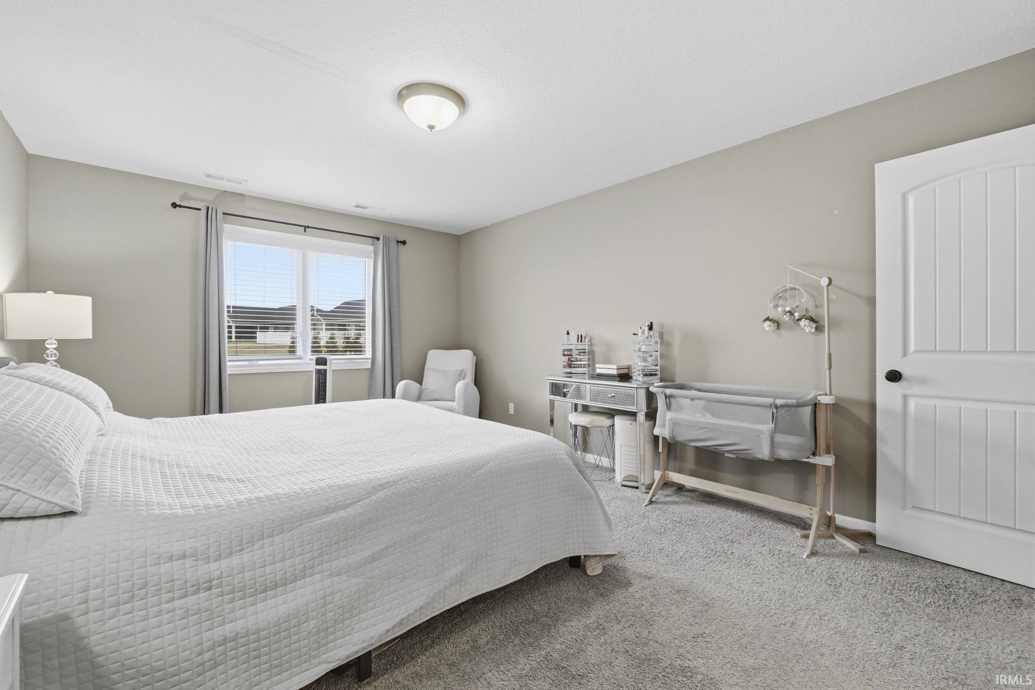 Bedroom featuring carpet flooring and baseboards