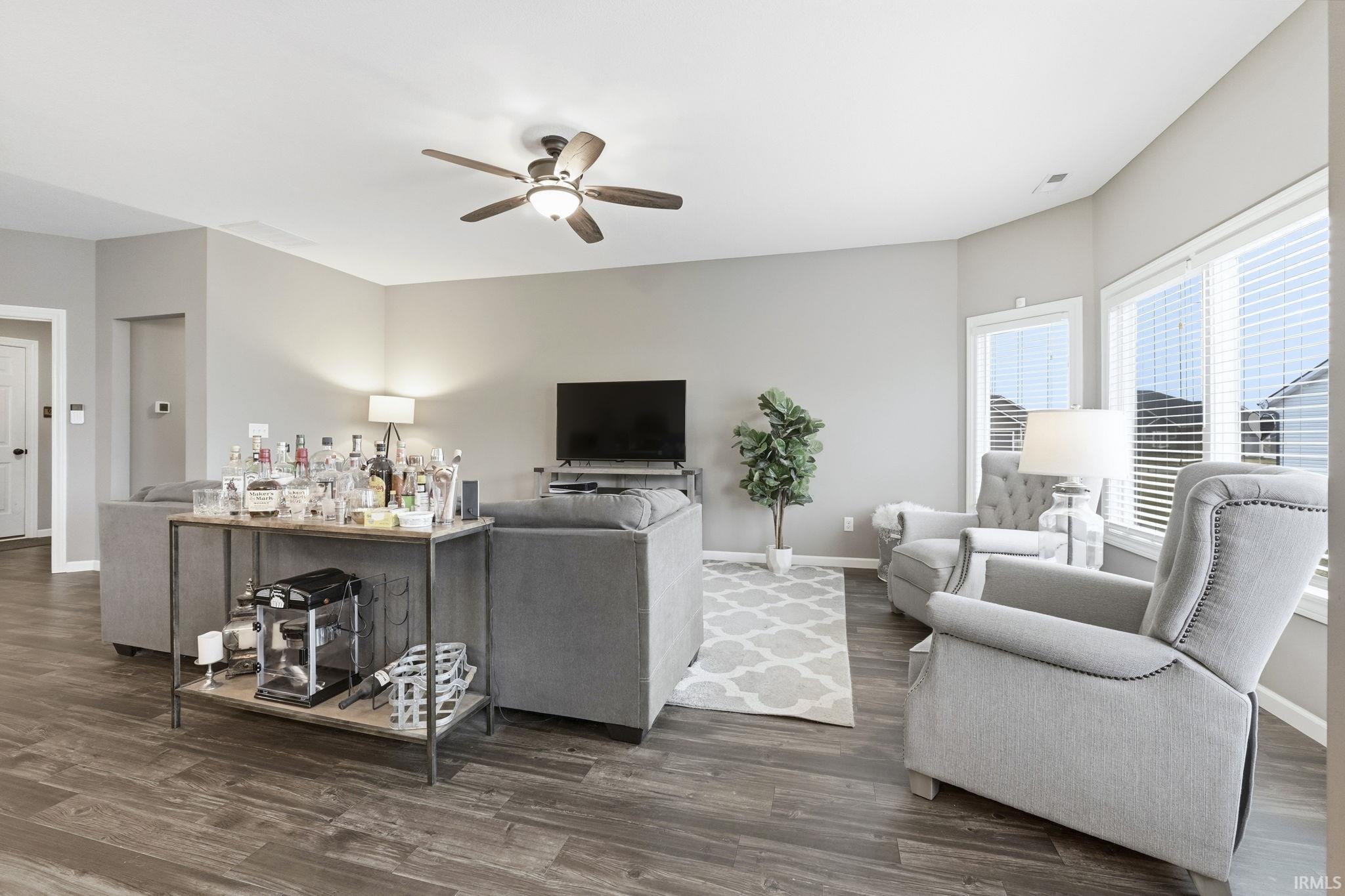 Living area featuring a ceiling fan and dark wood finished floors