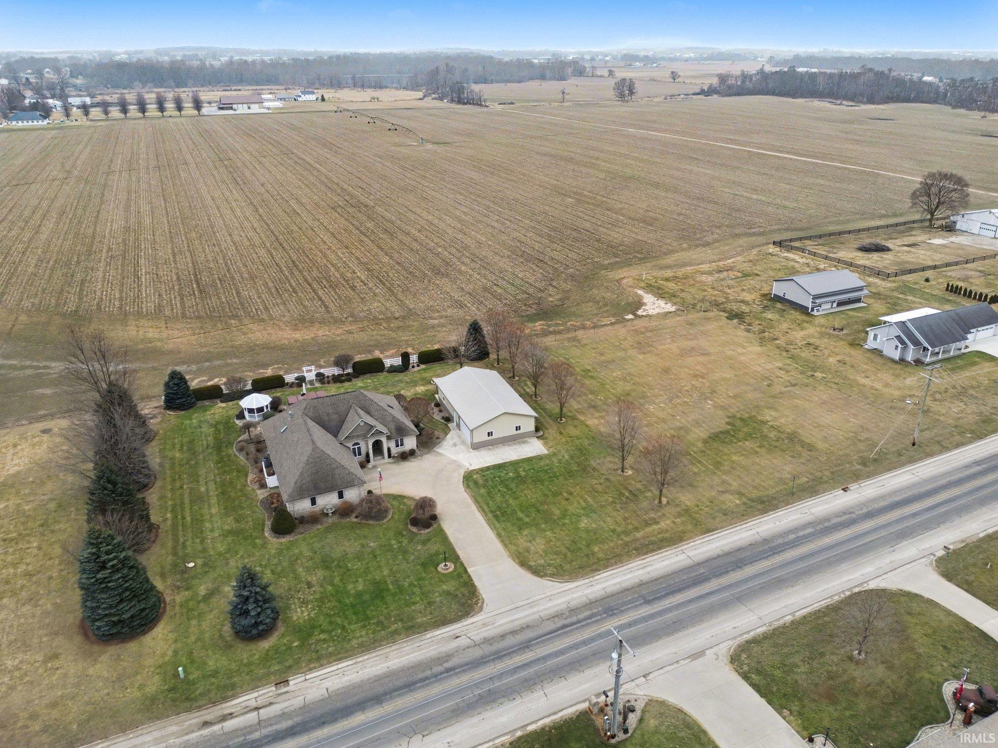 Aerial view of property's location with rural landscape and extensive farmland