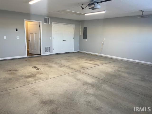 Garage featuring electric panel and a garage door opener