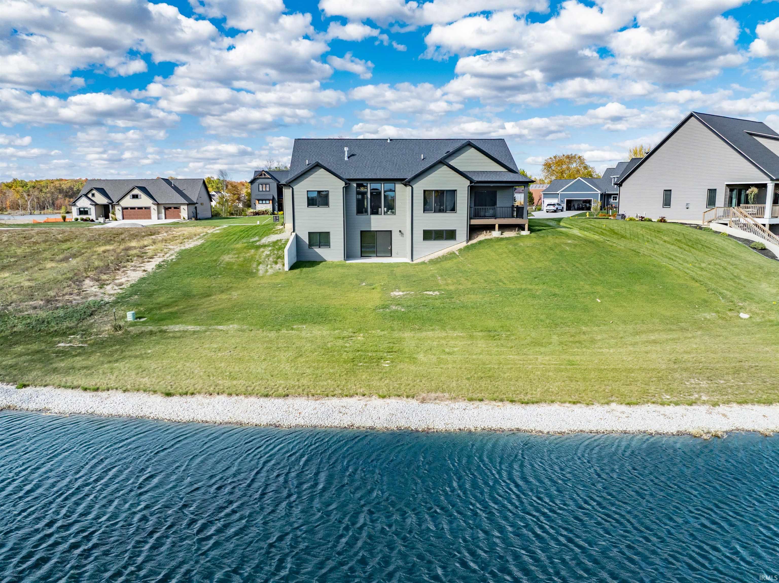 Aerial view of residential area featuring a large body of water