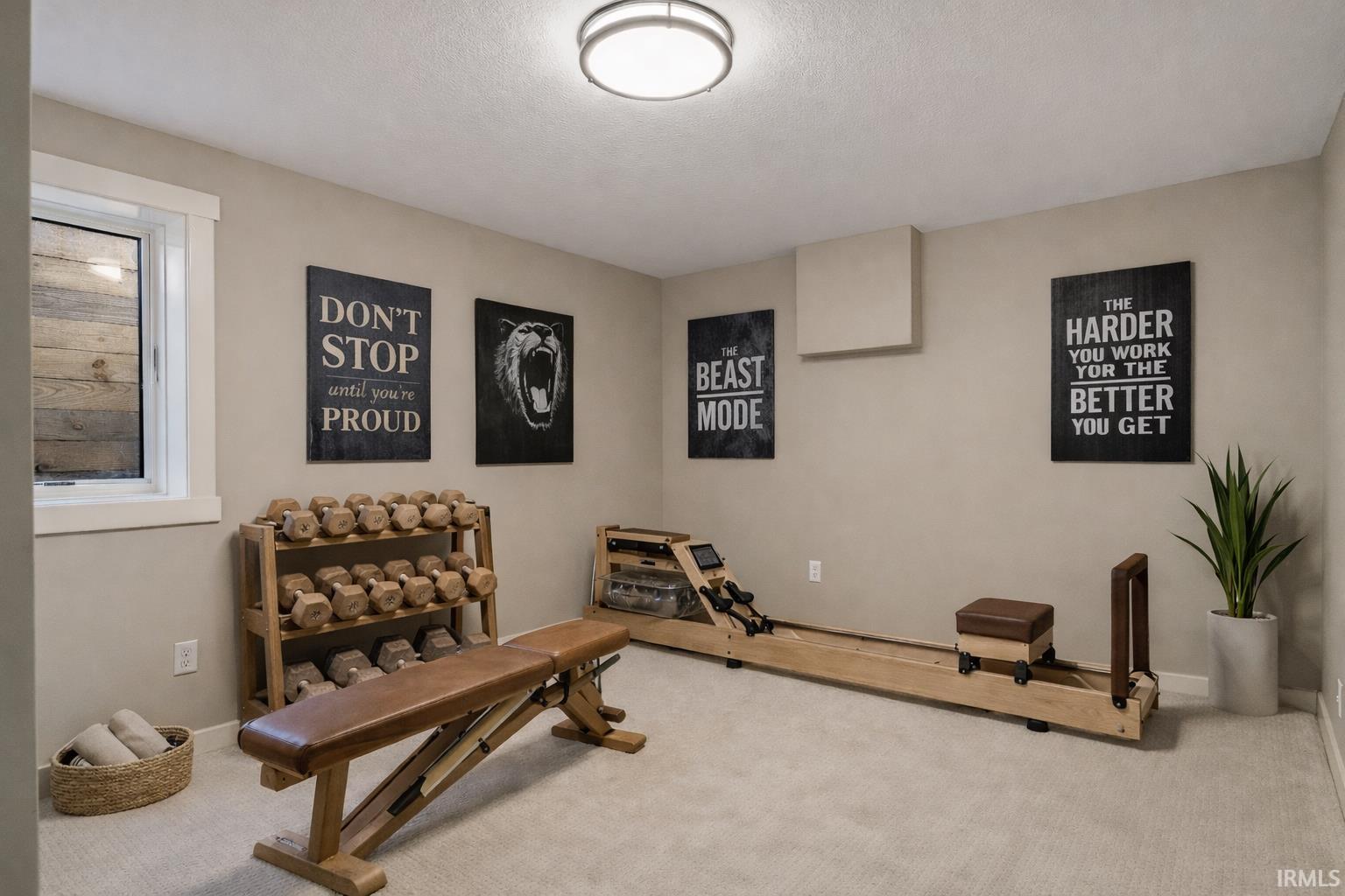 Workout room with carpet and baseboards