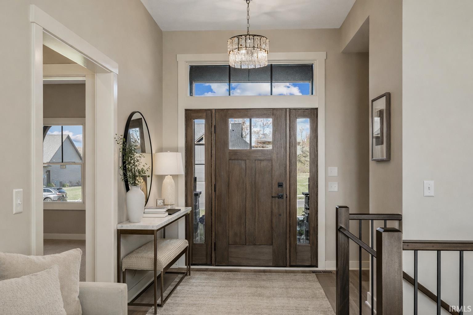 Entrance foyer with suspended lighting and plenty of natural light
