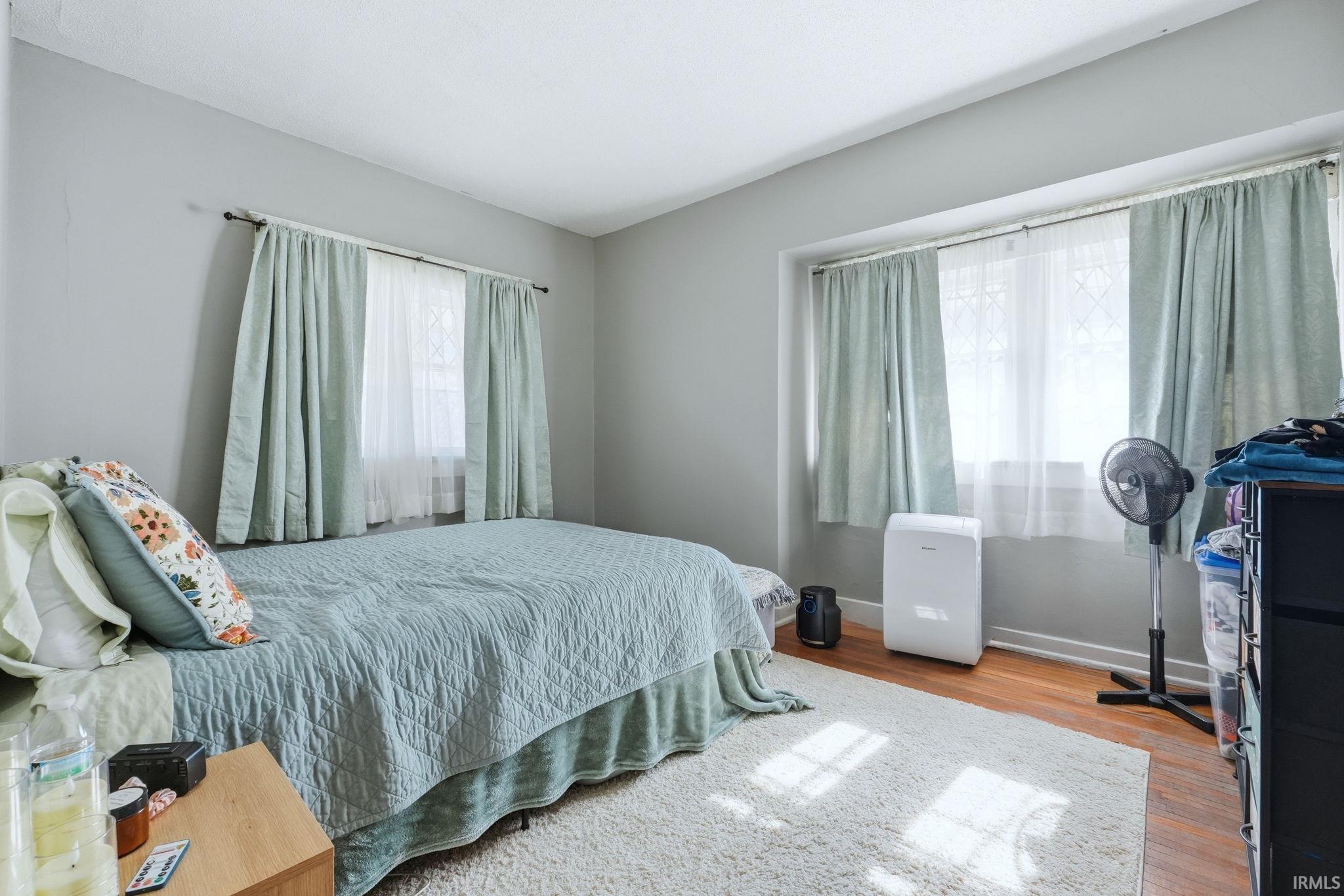 Bedroom with light wood finished floors and baseboards