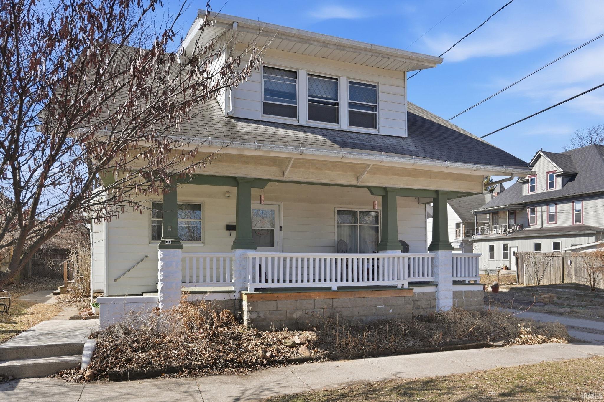 Bungalow-style home with covered porch and roof with shingles
