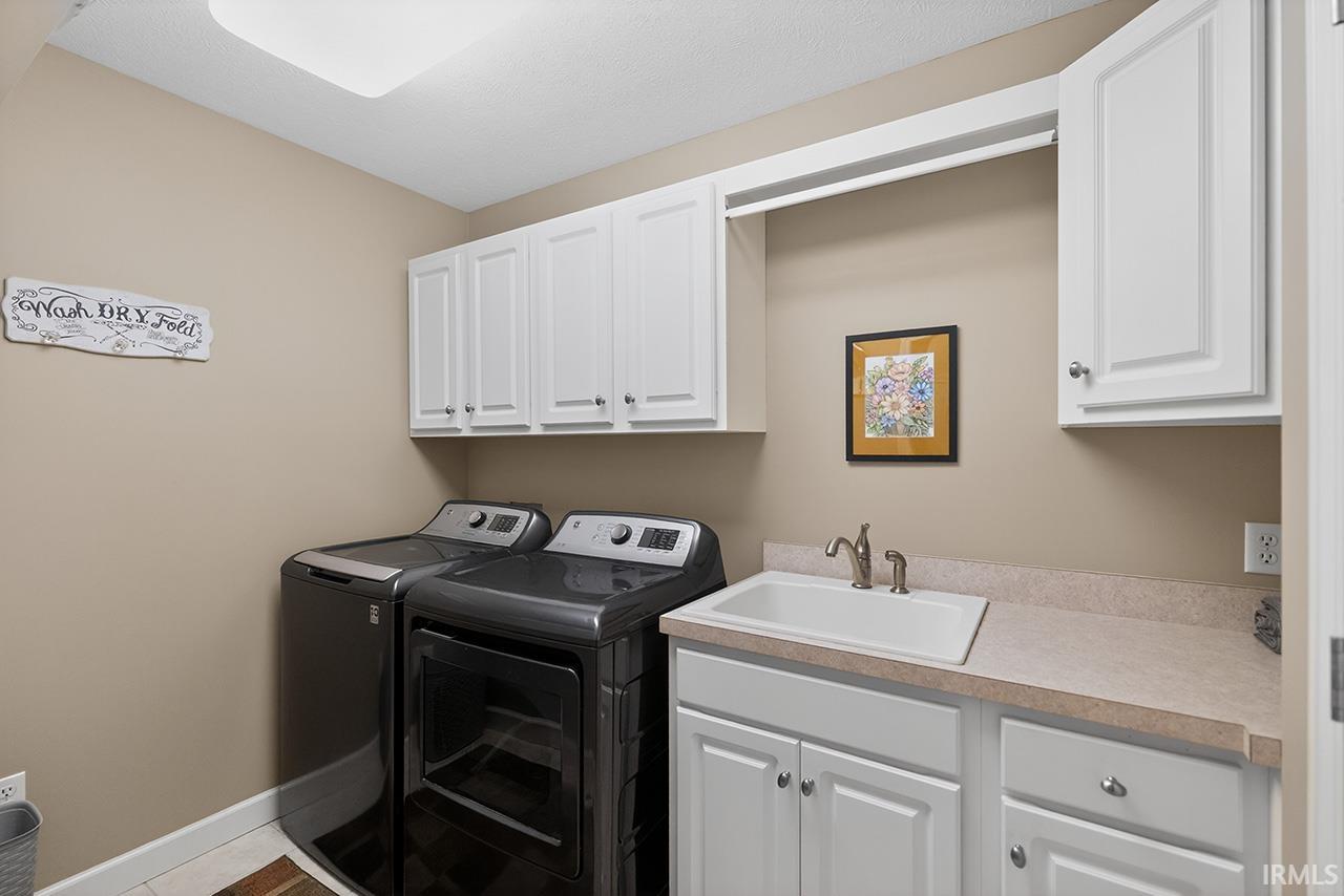 Laundry area with washer and clothes dryer and cabinet space