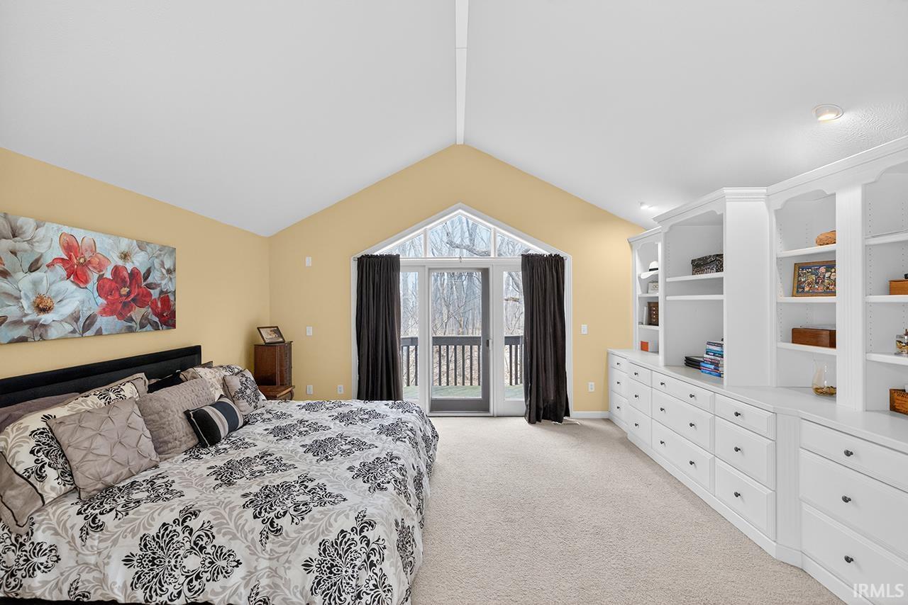 Bedroom featuring light colored carpet and access to exterior
