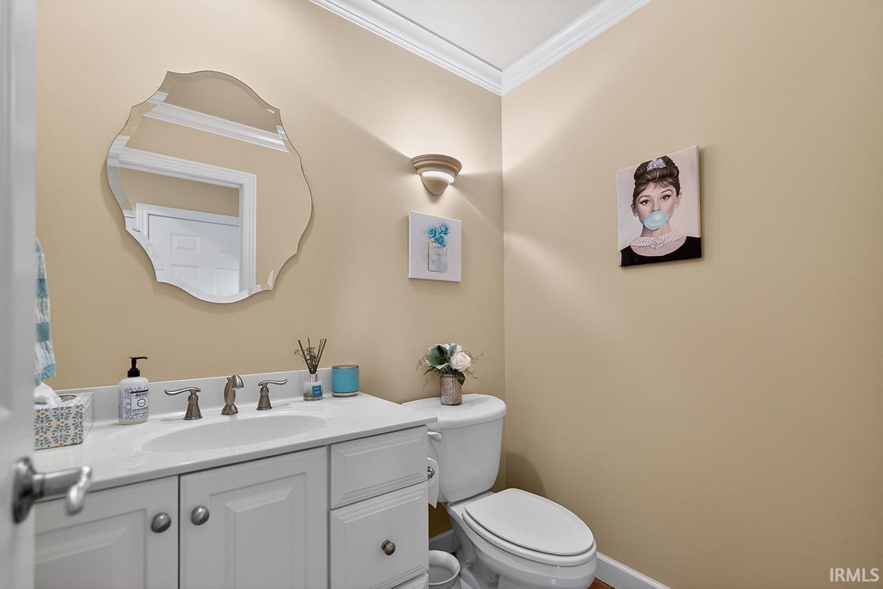 Bathroom featuring crown molding and vanity