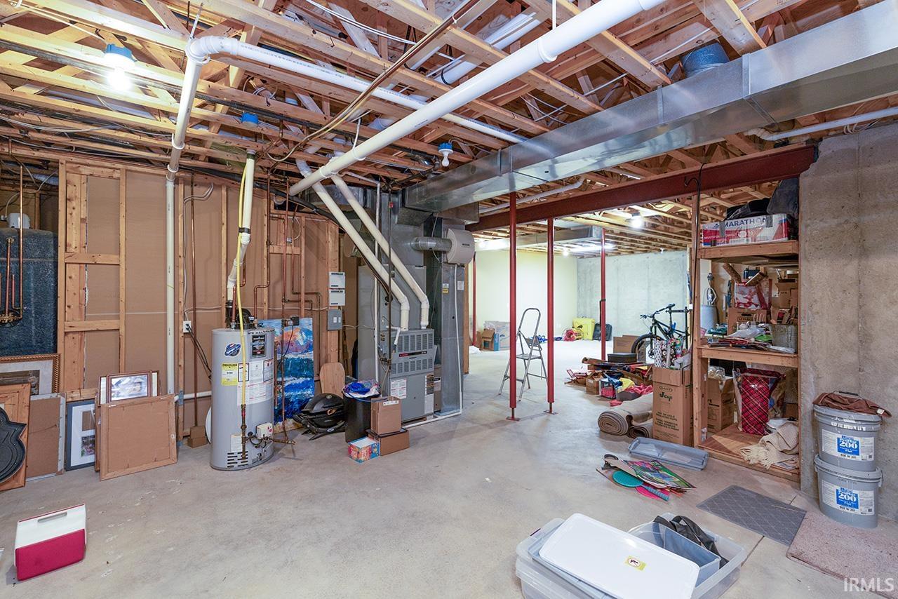 Unfinished basement with gas water heater and heating unit