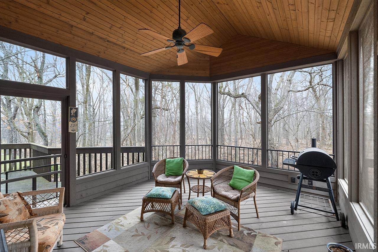 Sunroom / solarium featuring ceiling fan, vaulted ceiling, and plenty of natural light