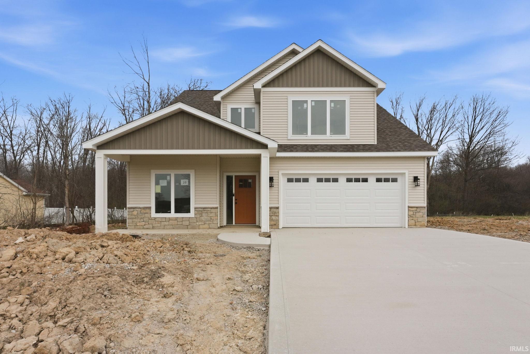 Craftsman-style home with stone siding, covered porch, driveway, and roof with shingles