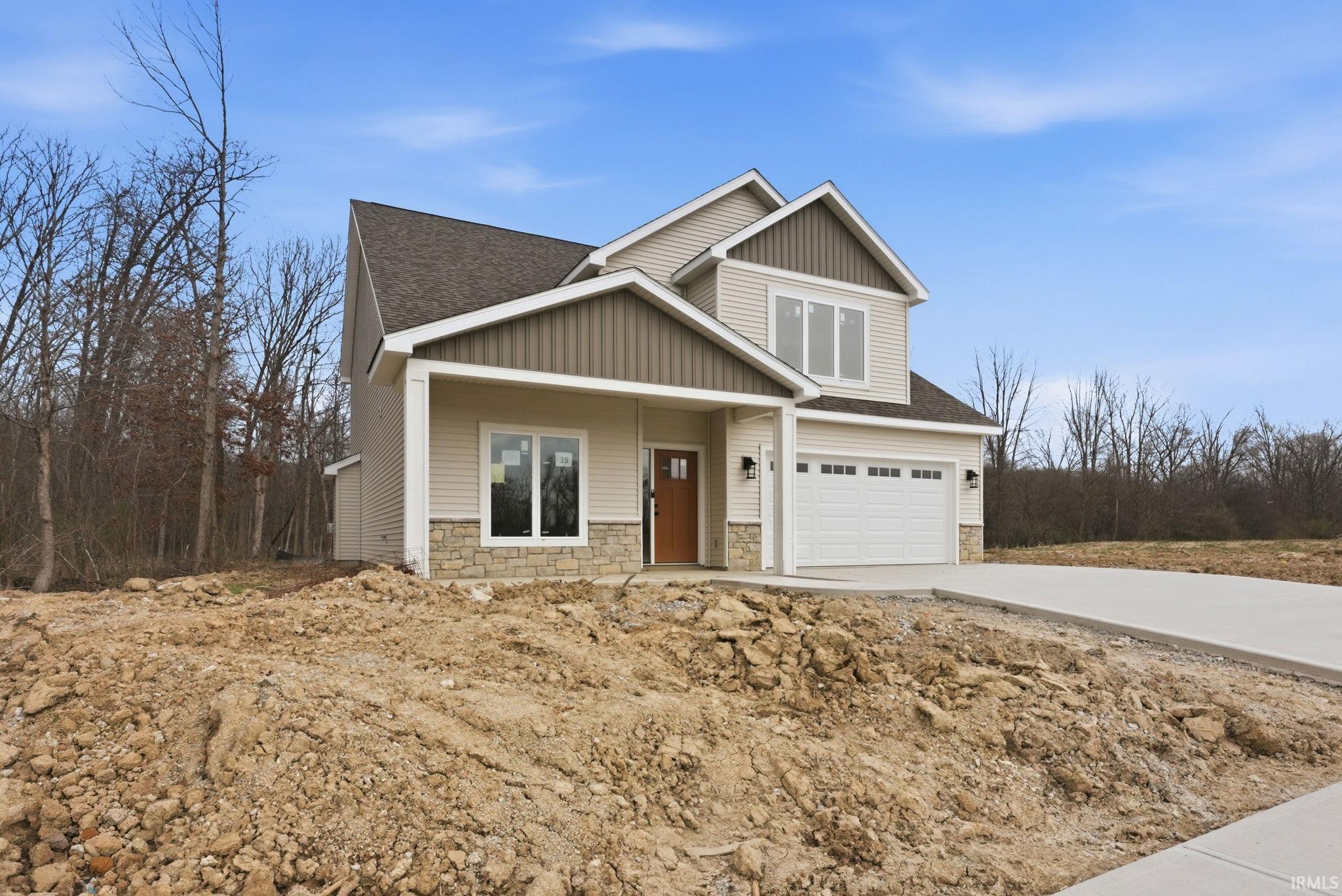 Craftsman-style house featuring stone siding, covered porch, driveway, a shingled roof, and a garage