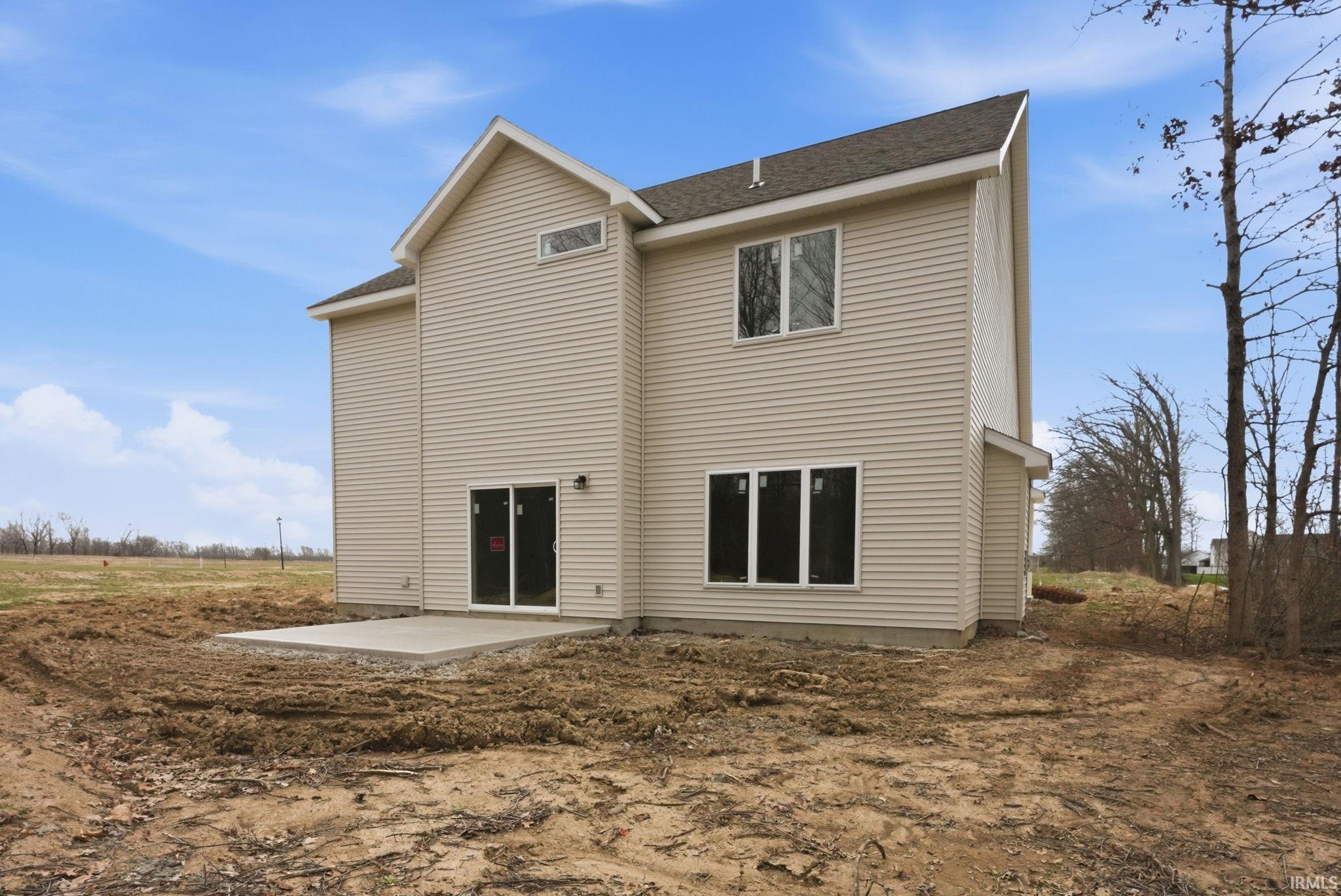 Back of property featuring a patio area and a shingled roof