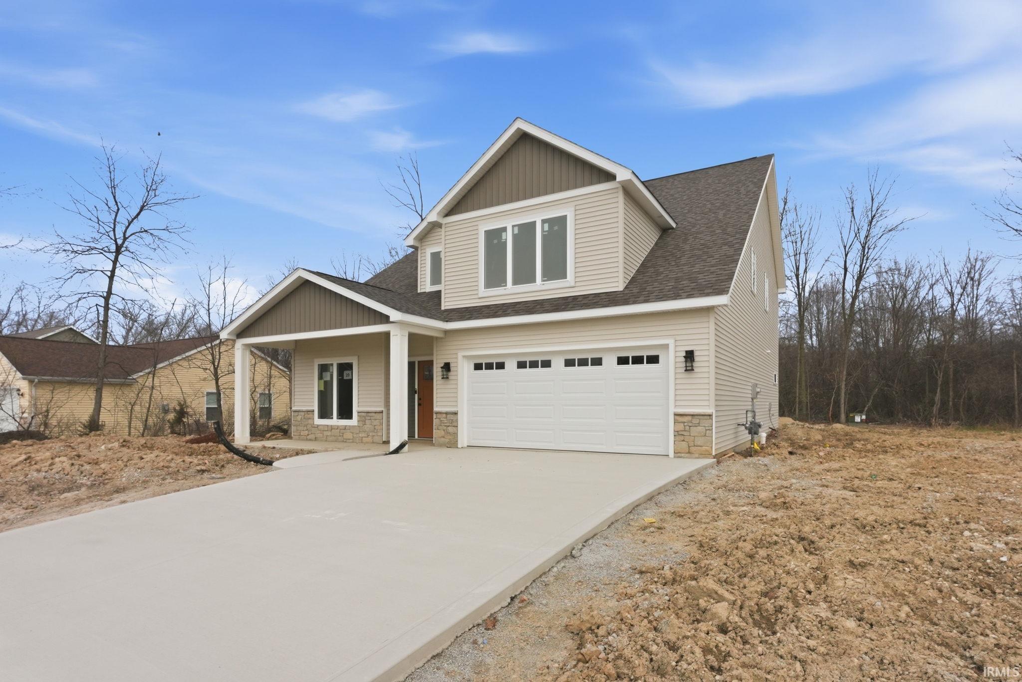 Craftsman-style home featuring stone siding, roof with shingles, concrete driveway, a porch, and an attached garage