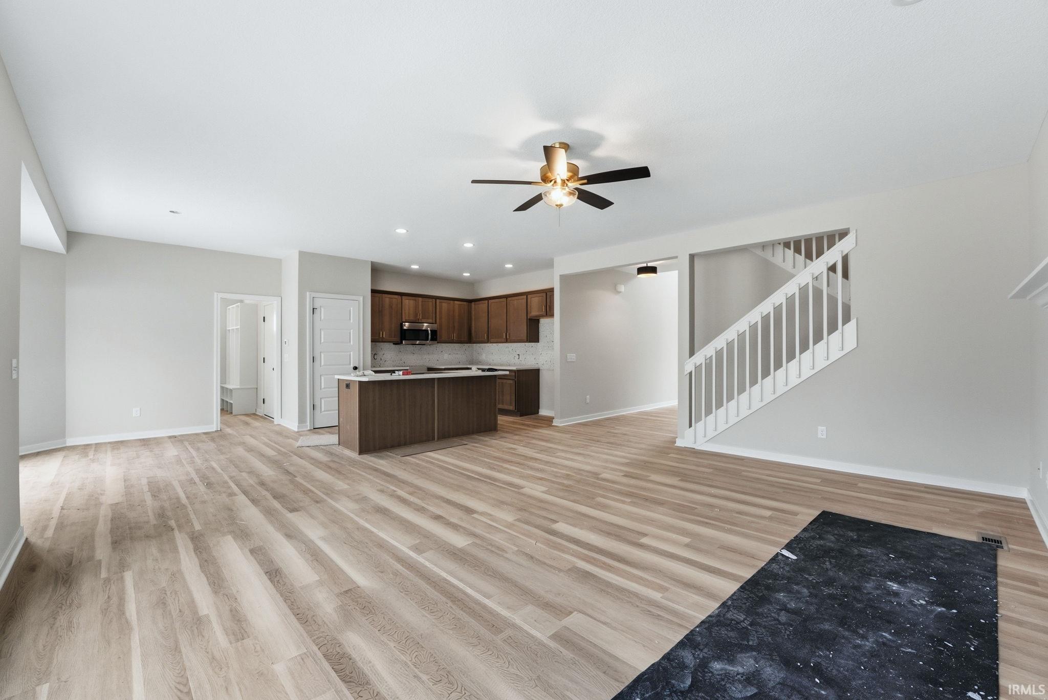 Unfurnished living room with a ceiling fan, light wood-style floors, and recessed lighting