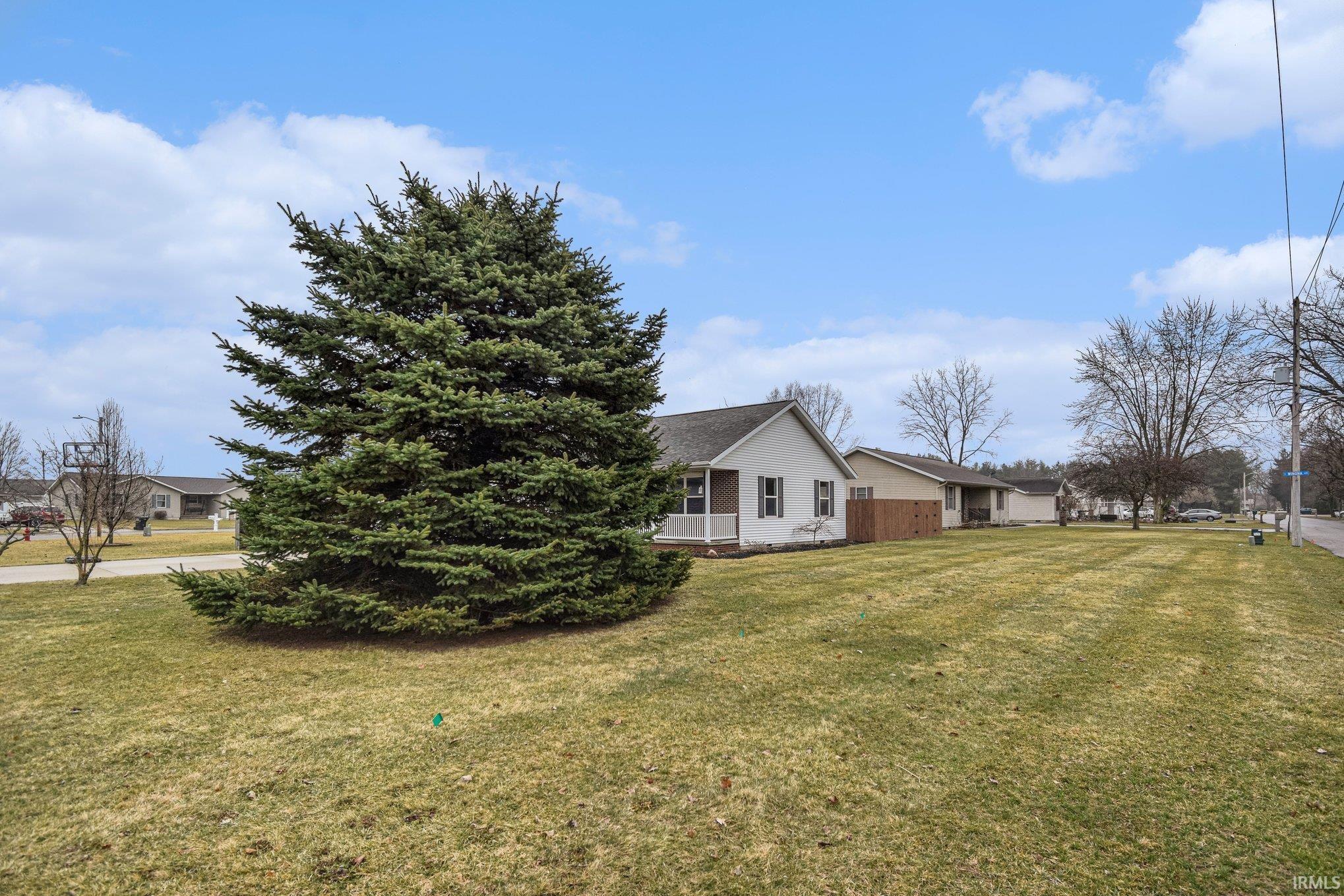 View of side of home featuring a yard
