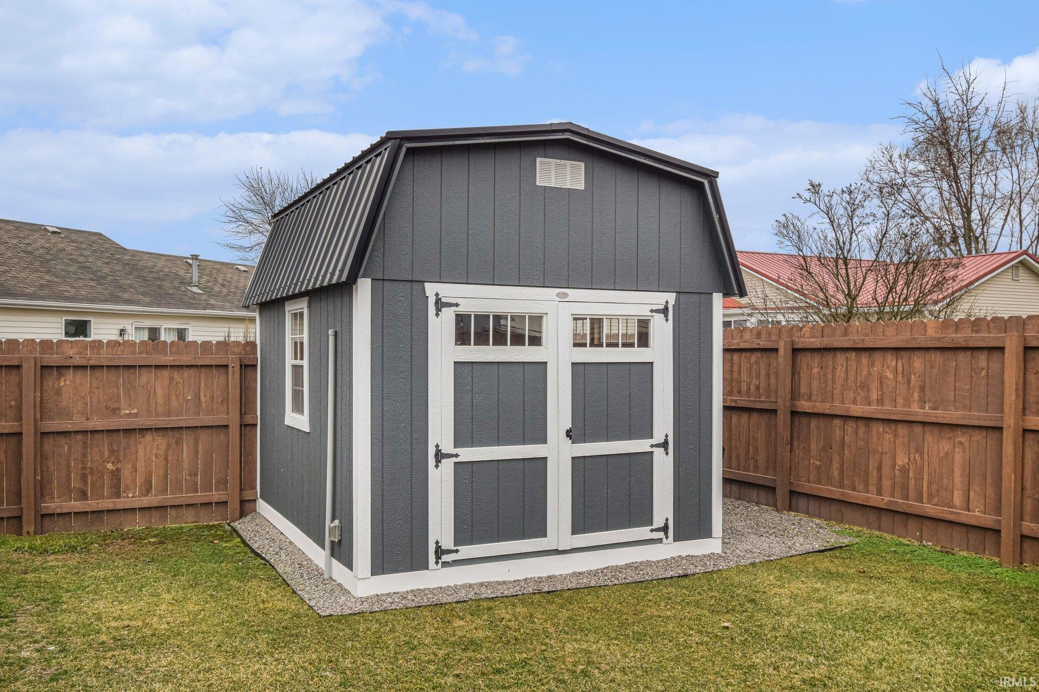 View of shed with a fenced backyard