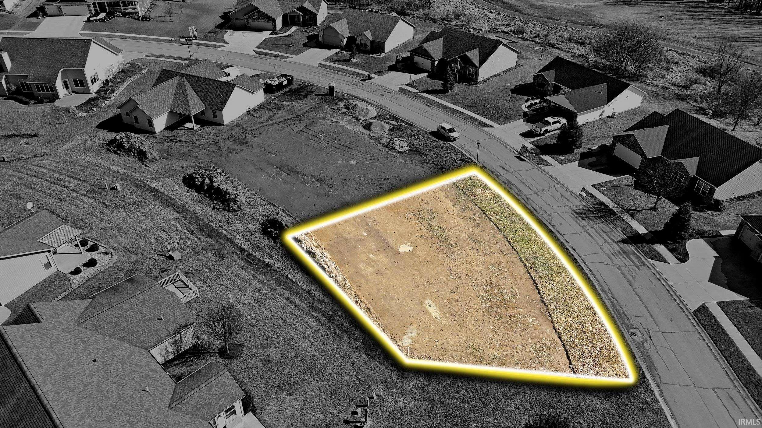 Aerial view of residential area featuring property boundaries highlighted