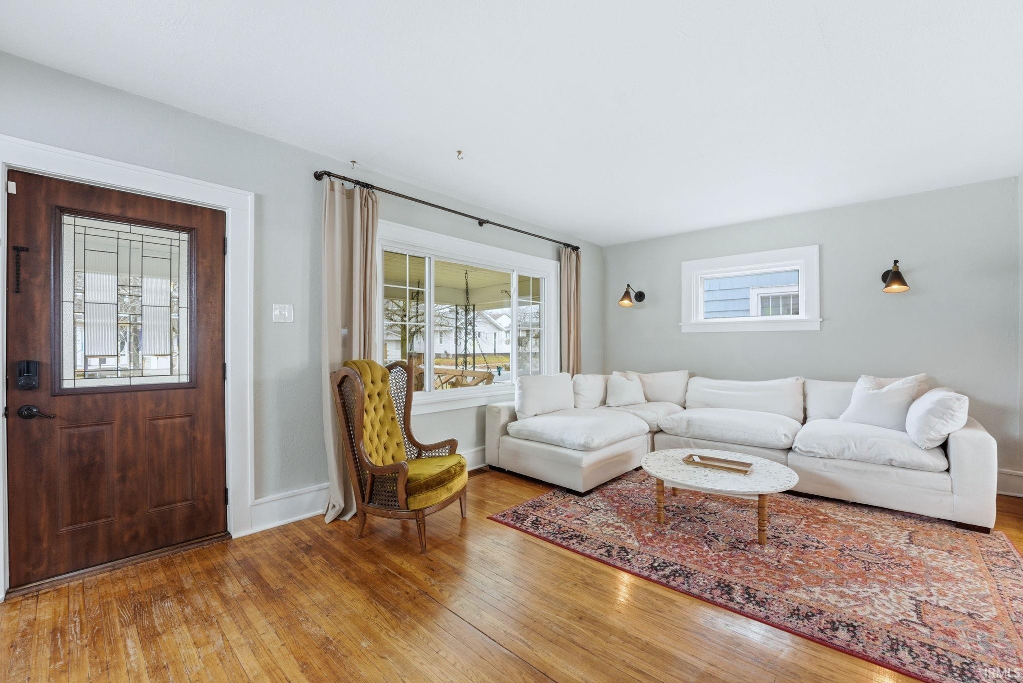 Living room with light wood-type flooring and baseboards