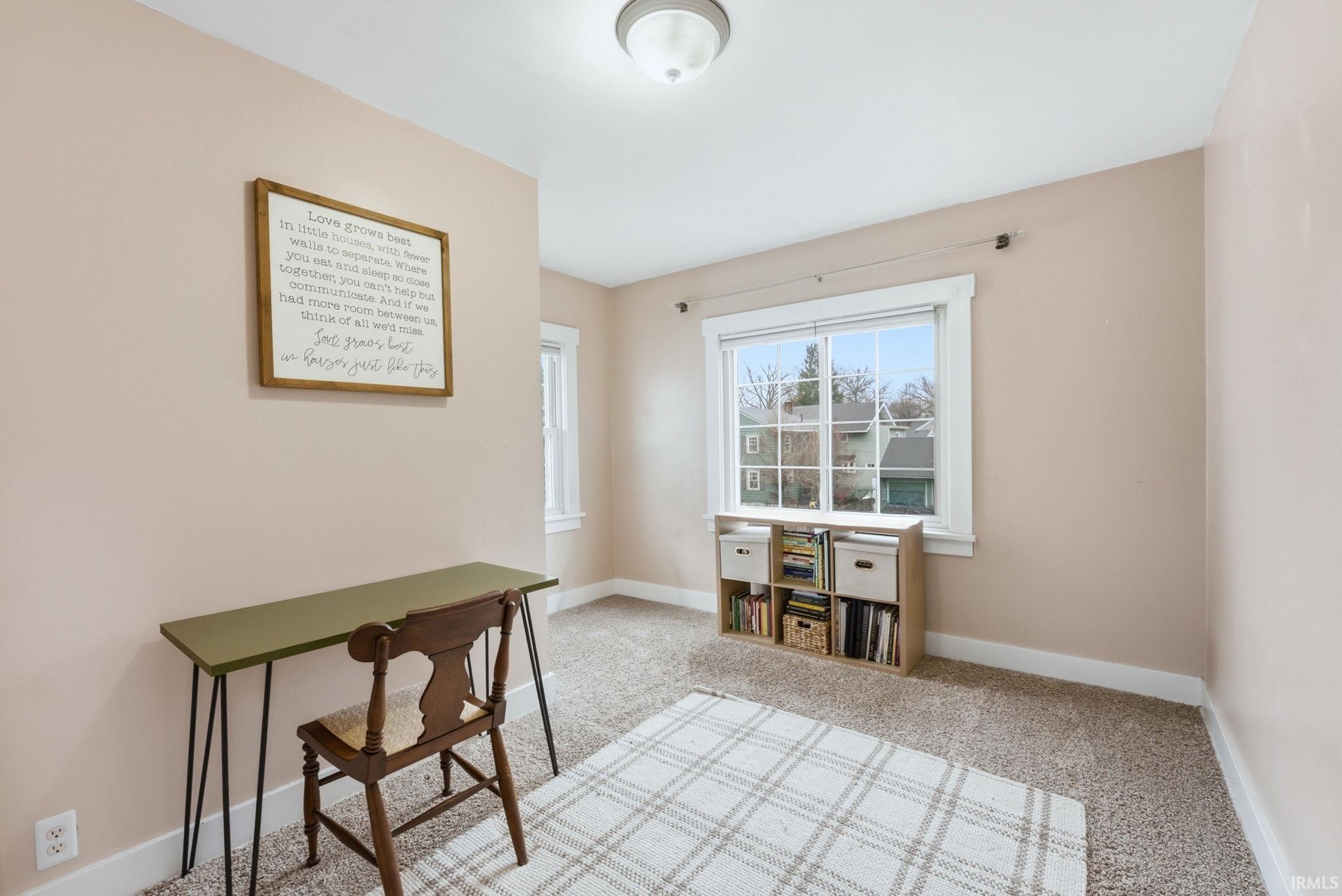 Office featuring light carpet and baseboards