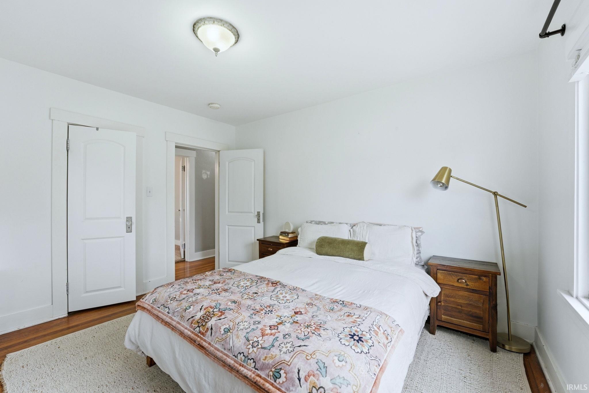 Bedroom featuring baseboards and wood finished floors