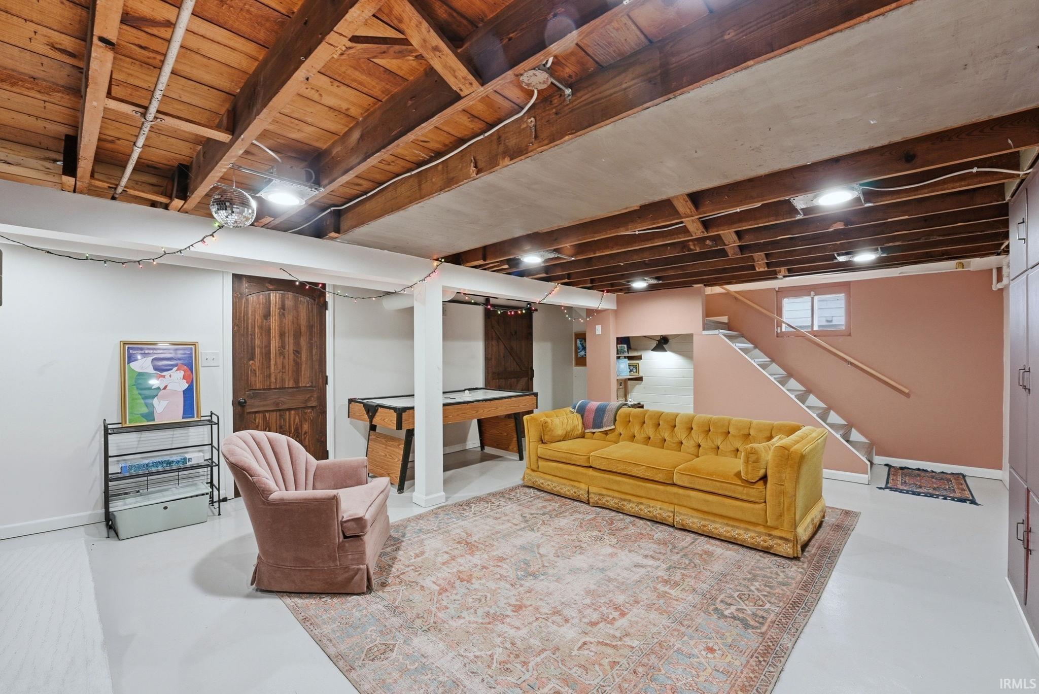 Living area featuring finished concrete floors and pool table