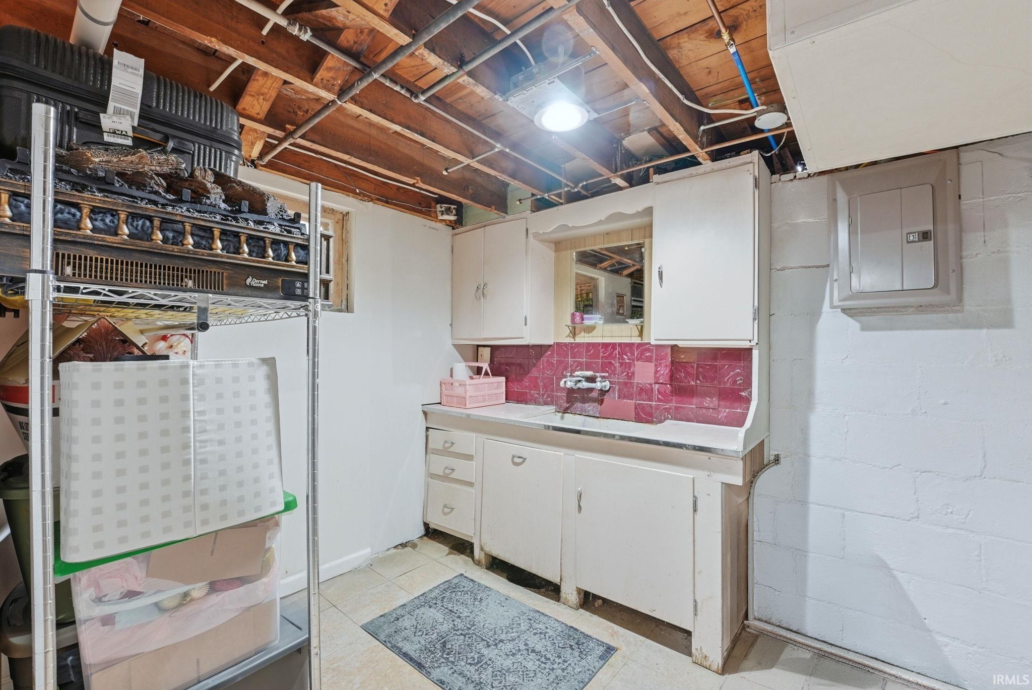 Unfinished below grade area featuring electric panel