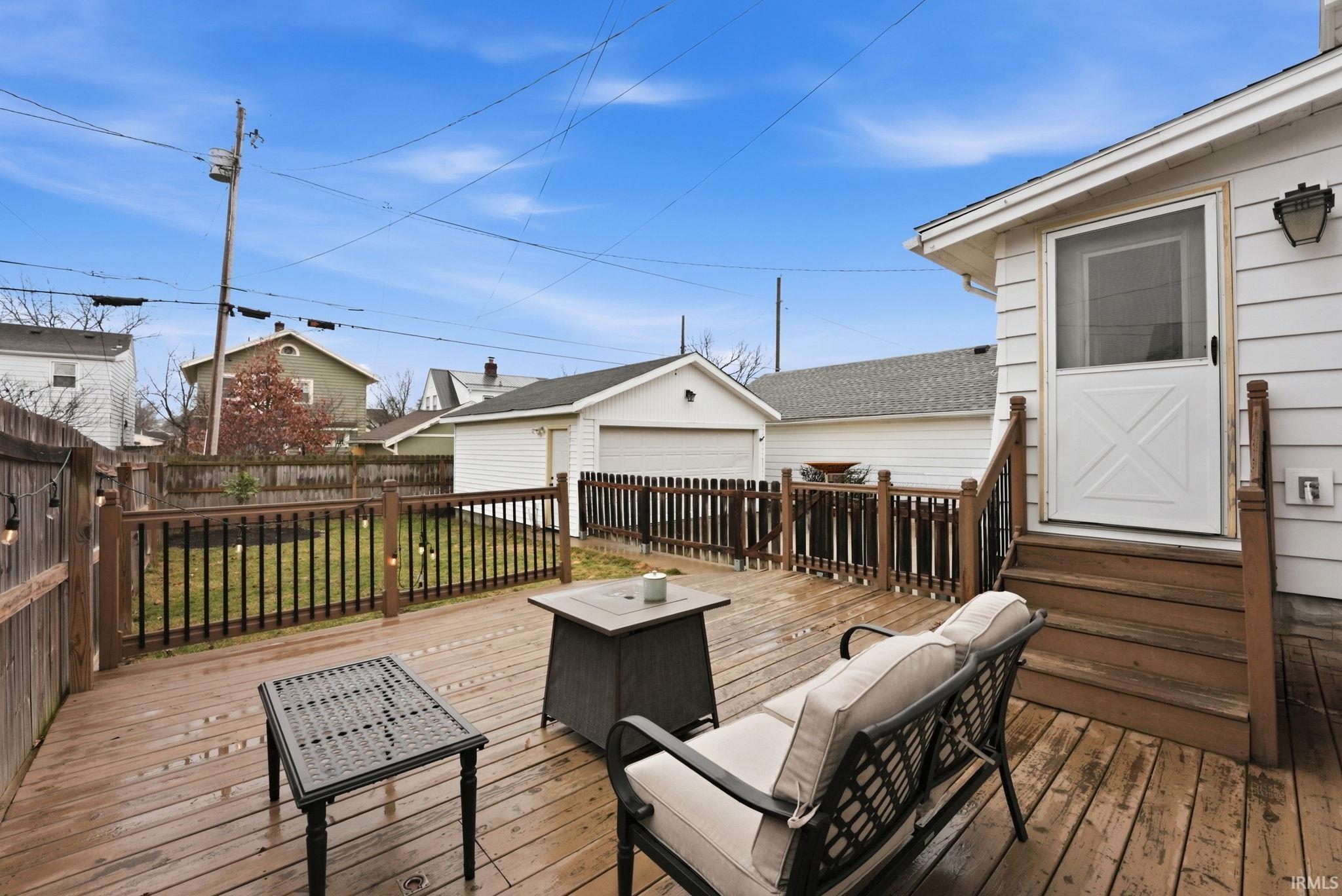 Deck featuring an outdoor structure, entry steps, and a residential view