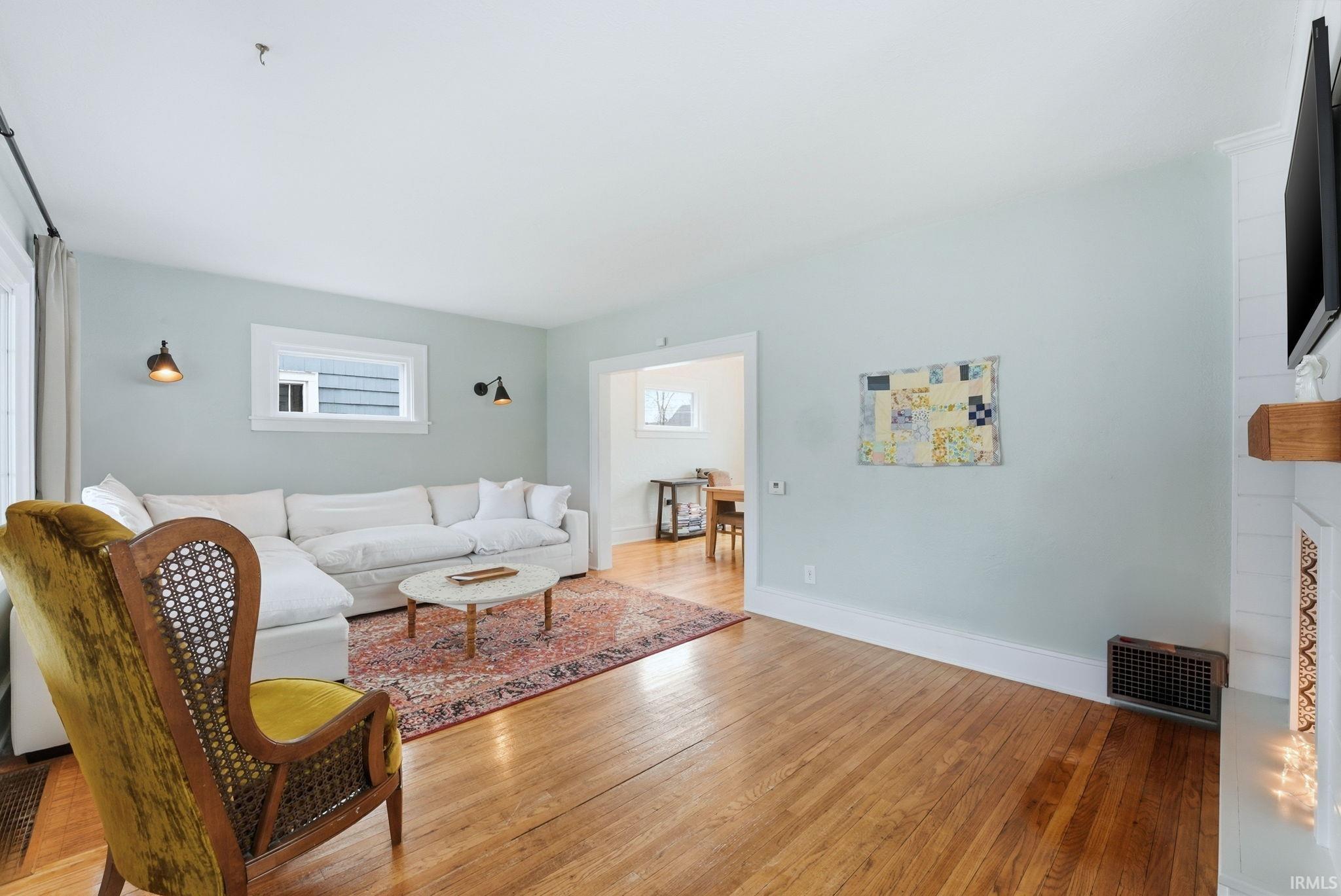 Living room with light wood-style flooring and a fireplace