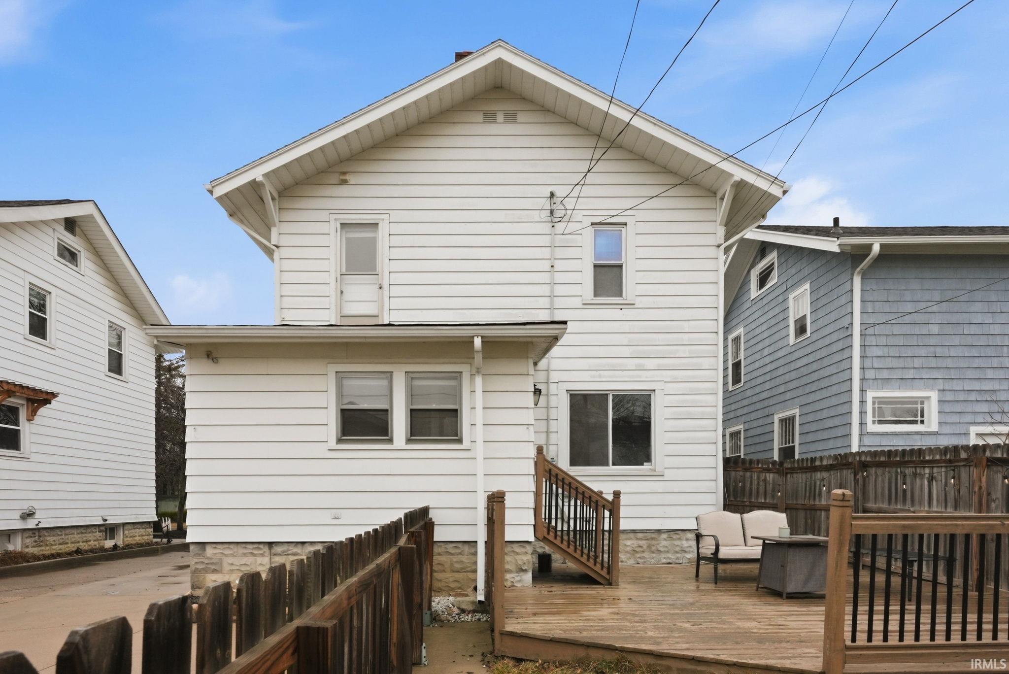 Back of property with a wooden deck