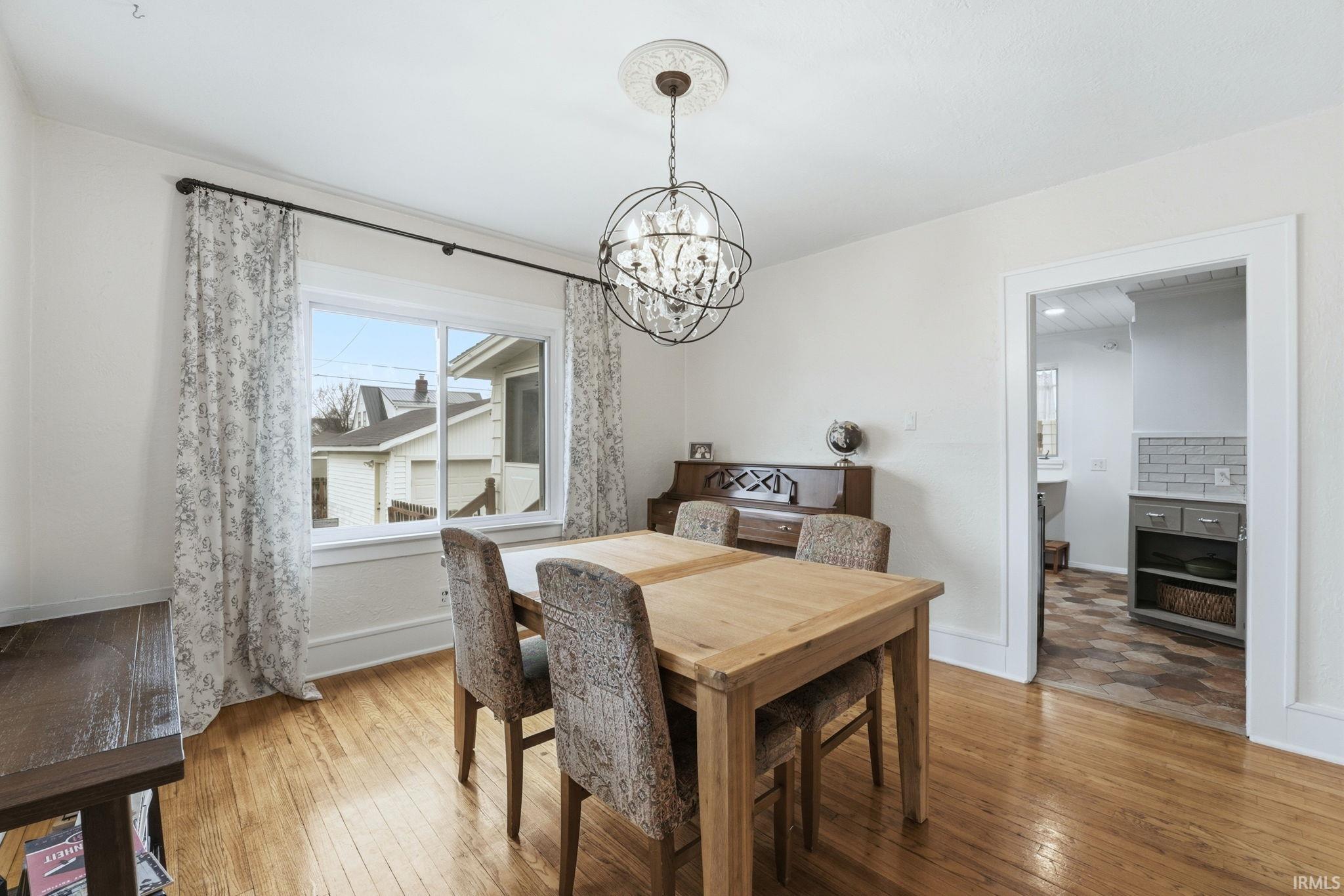 Dining room with a chandelier and light wood-style floors