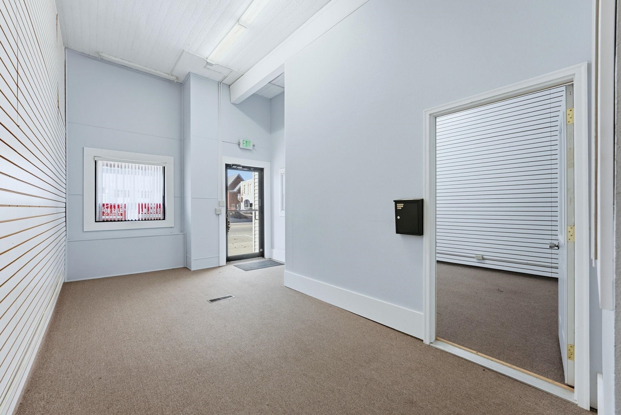 Spare room with light colored carpet and a high ceiling