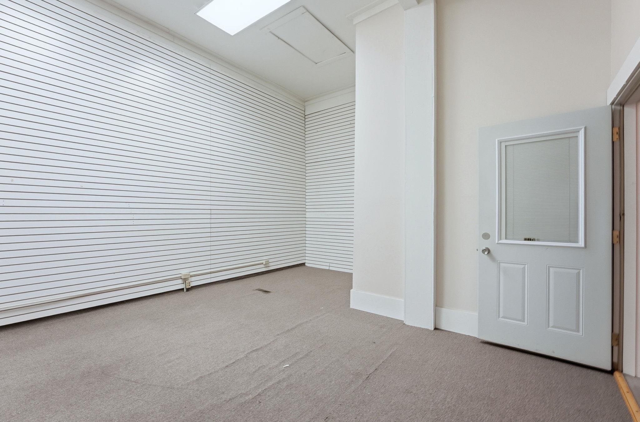 Empty room featuring light colored carpet and crown molding
