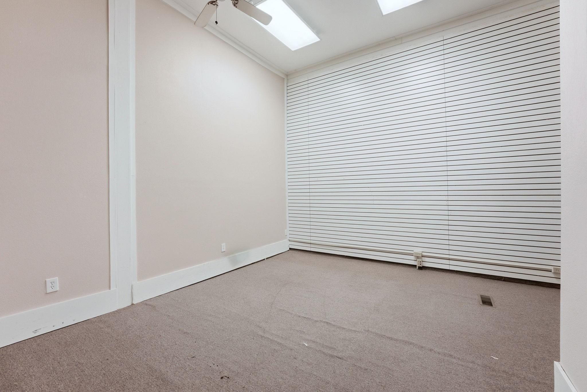 Empty room with carpet, ceiling fan, and ornamental molding