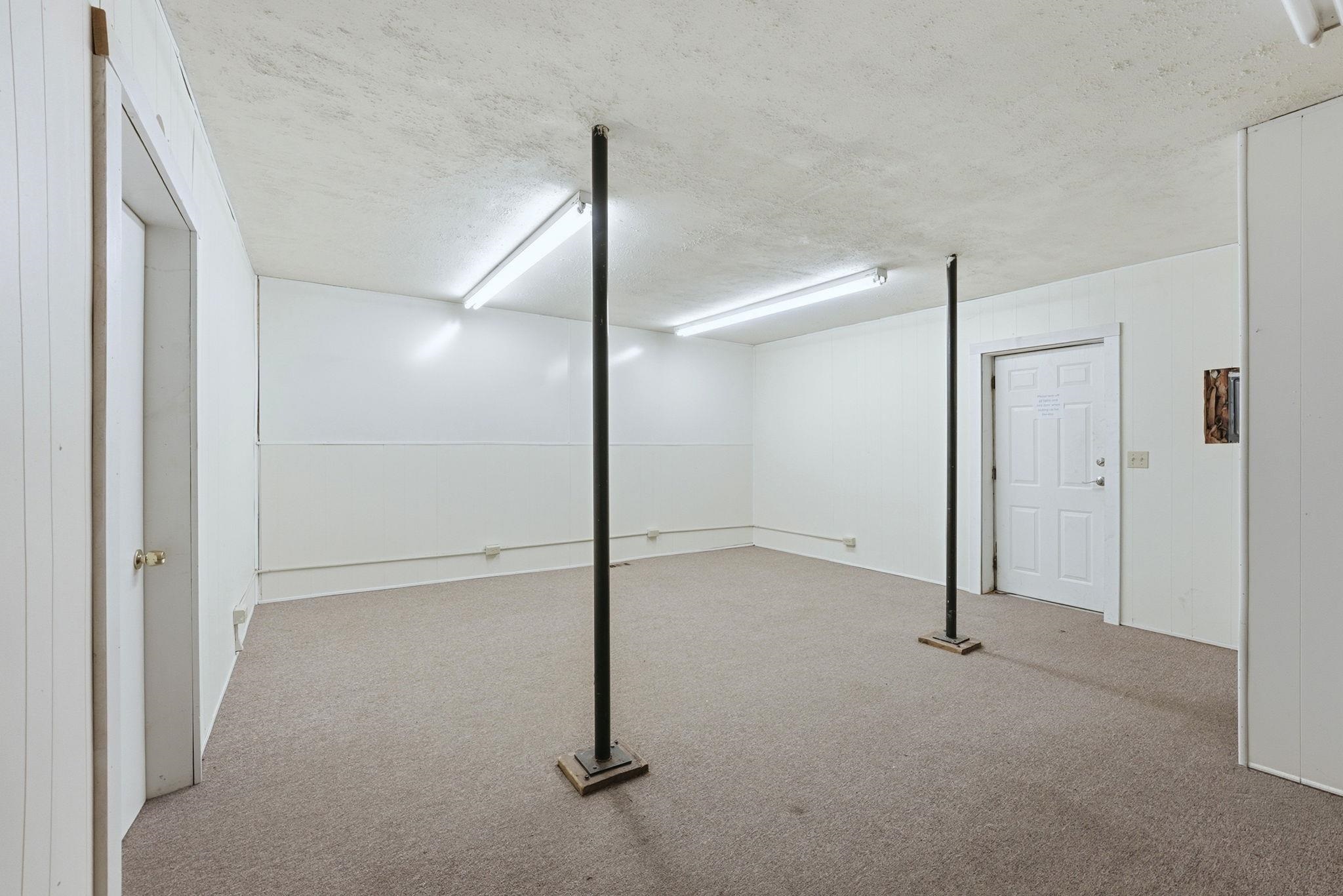 Finished below grade area featuring carpet and a textured ceiling