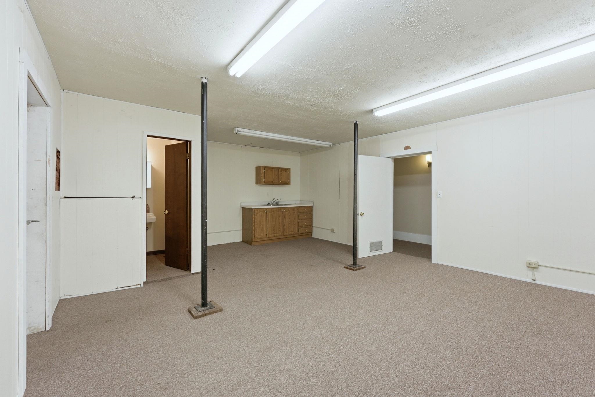Finished below grade area with a textured ceiling and light colored carpet
