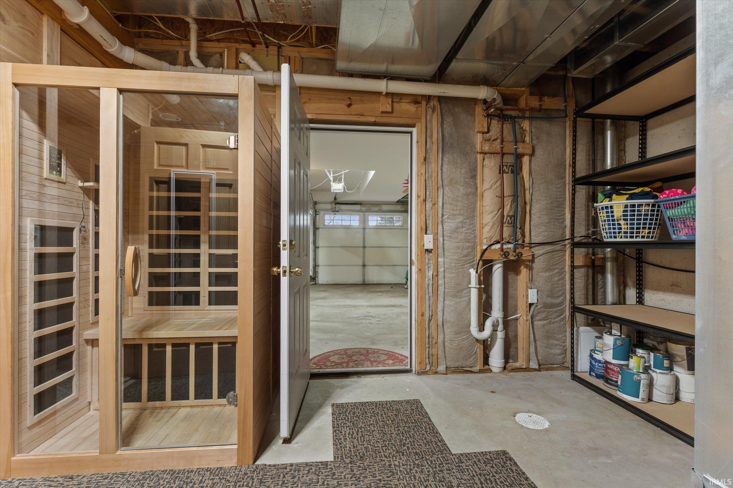 Misc room featuring a relaxing sauna and concrete flooring