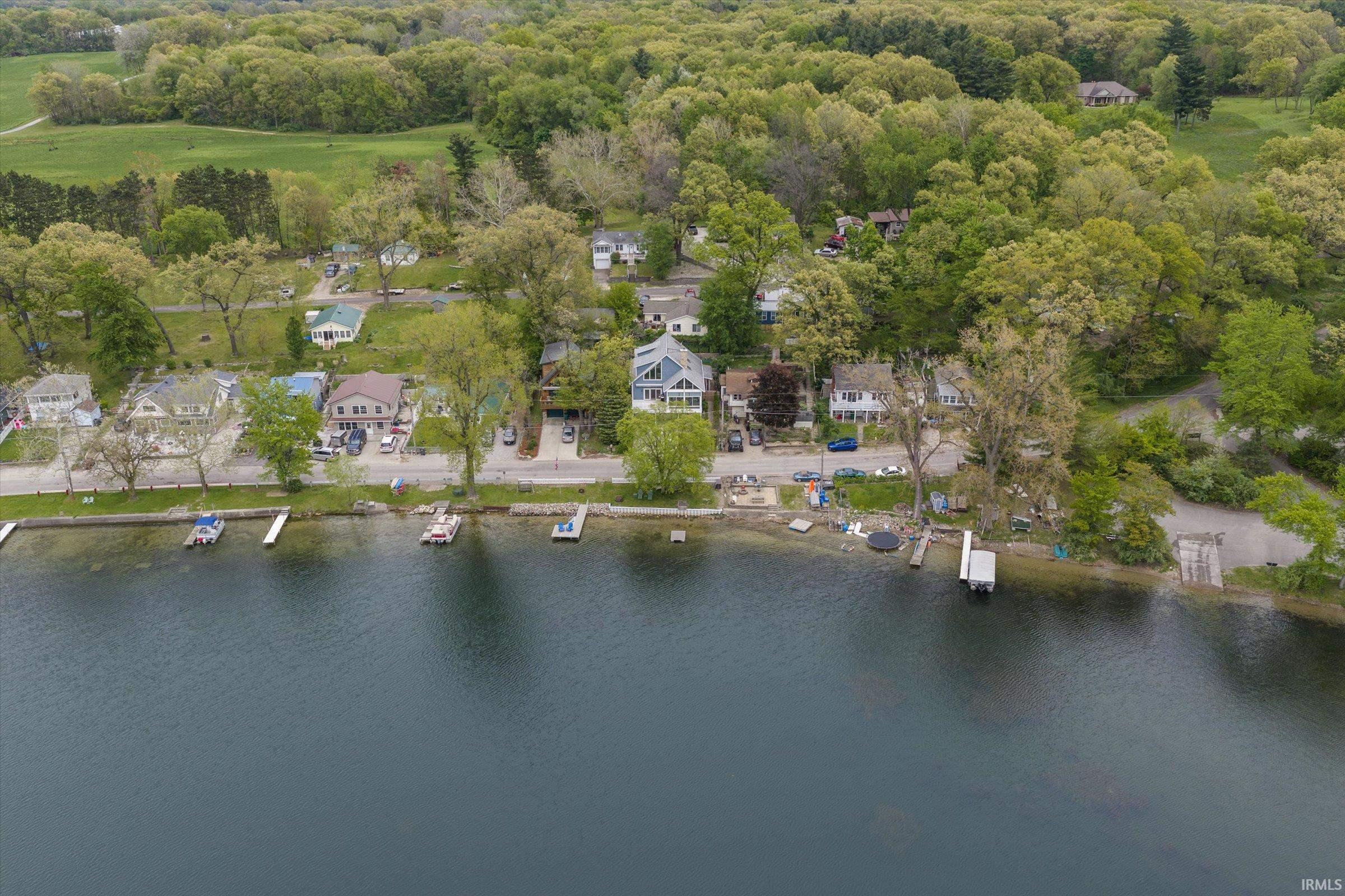 Waterfront properties featuring private docks and mature trees