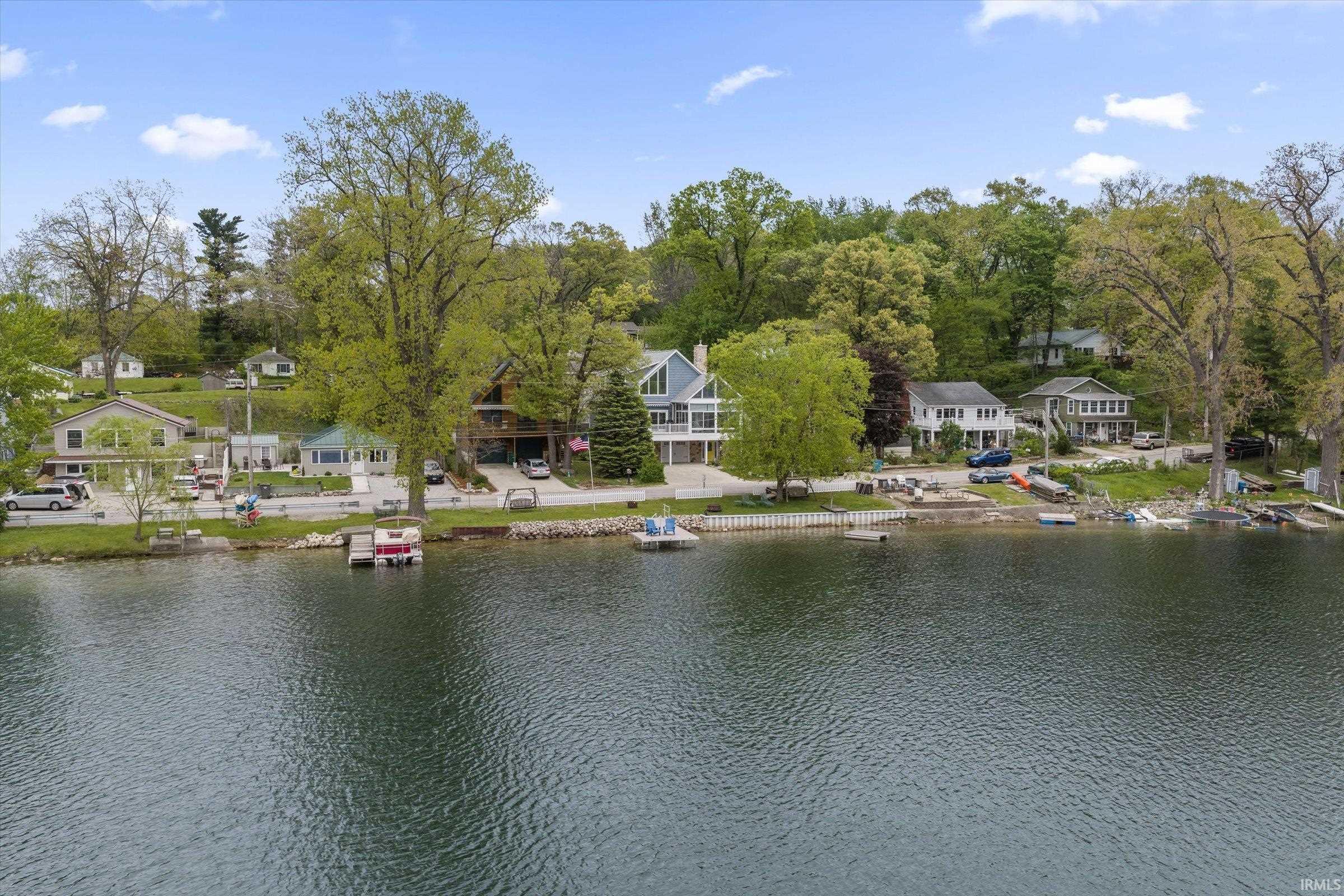 Lakeside properties featuring established landscaping, private boat docks, and direct water access